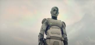 Murderbot, fully in its armor, looking down at the viewer