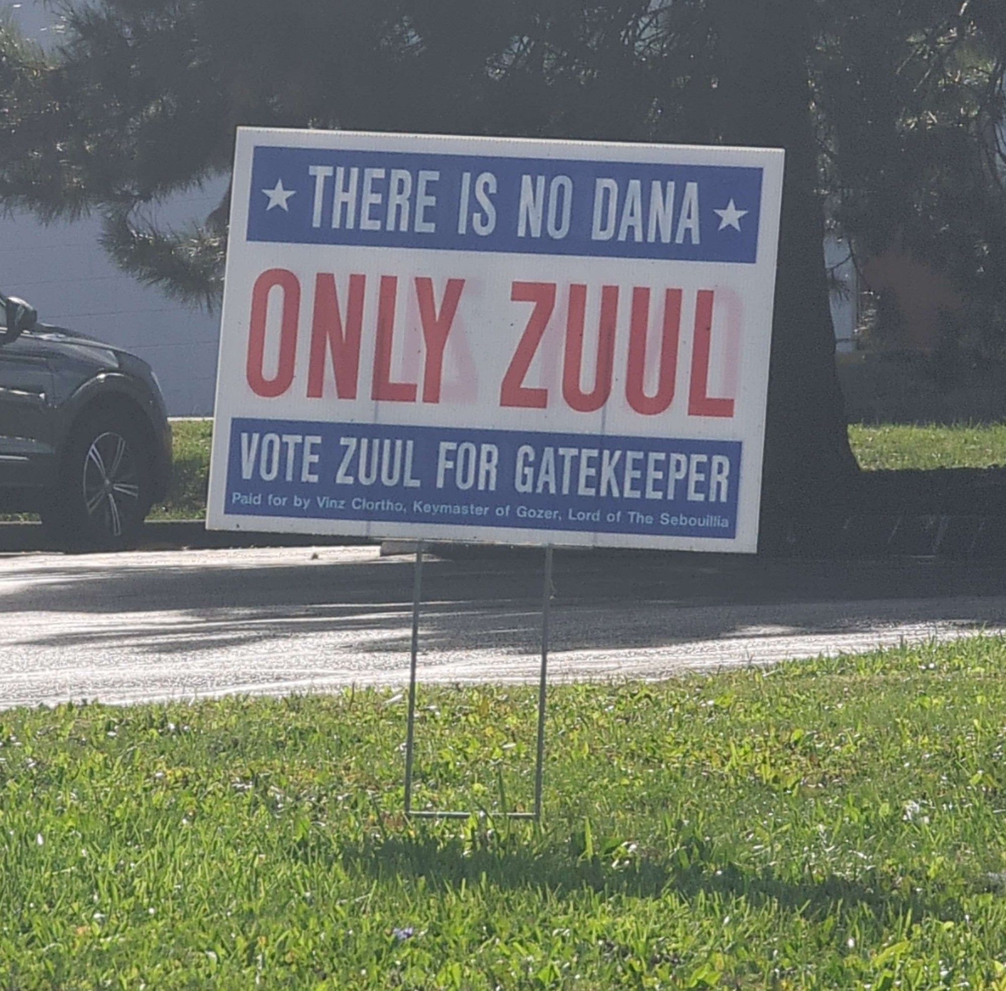 A political sign for the republican candidate for Ohio, it sits on a trimmed lawn, it says: There is no Dana Only Zuul Vote Zuul For Gatekeeper