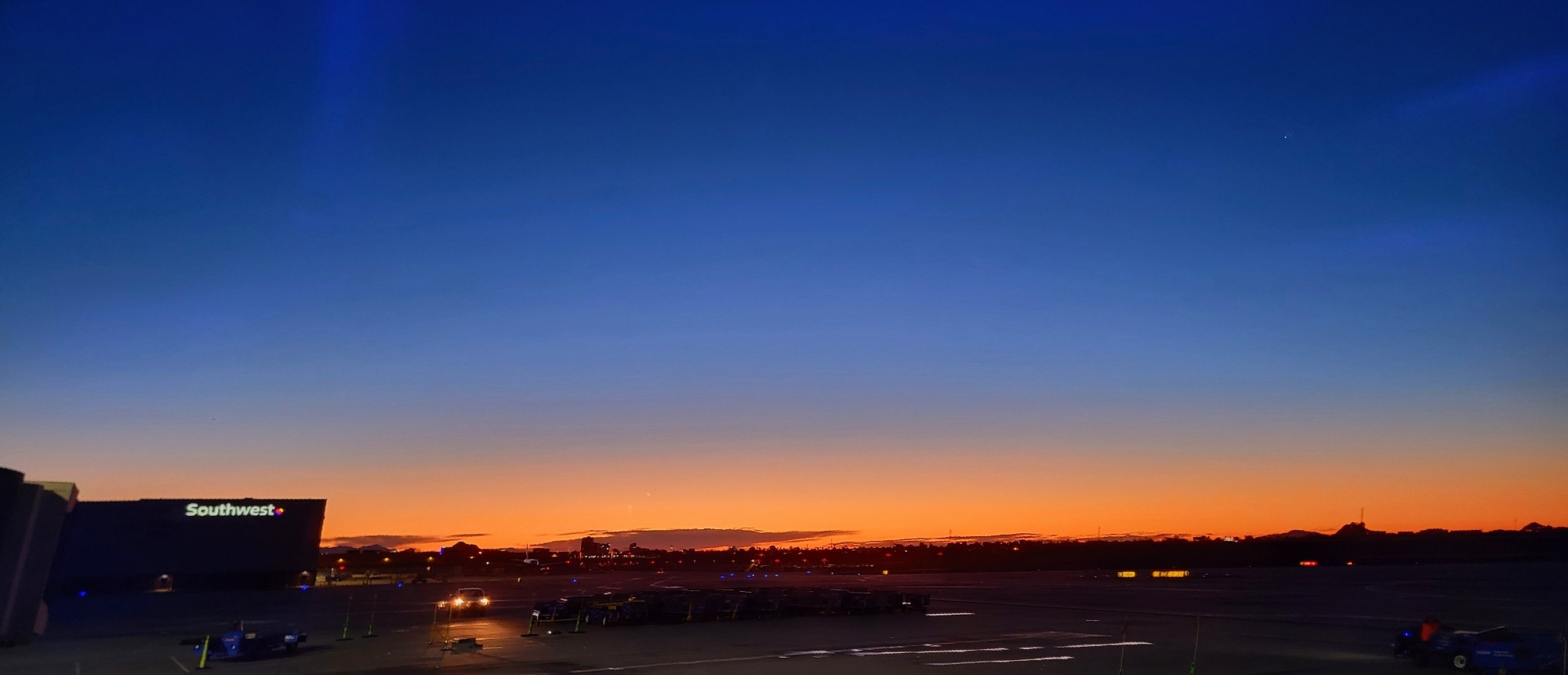 Sunrise over Sky Harbor International airport in Phoenix, Arizona. Dark blue sky lighting on fire.