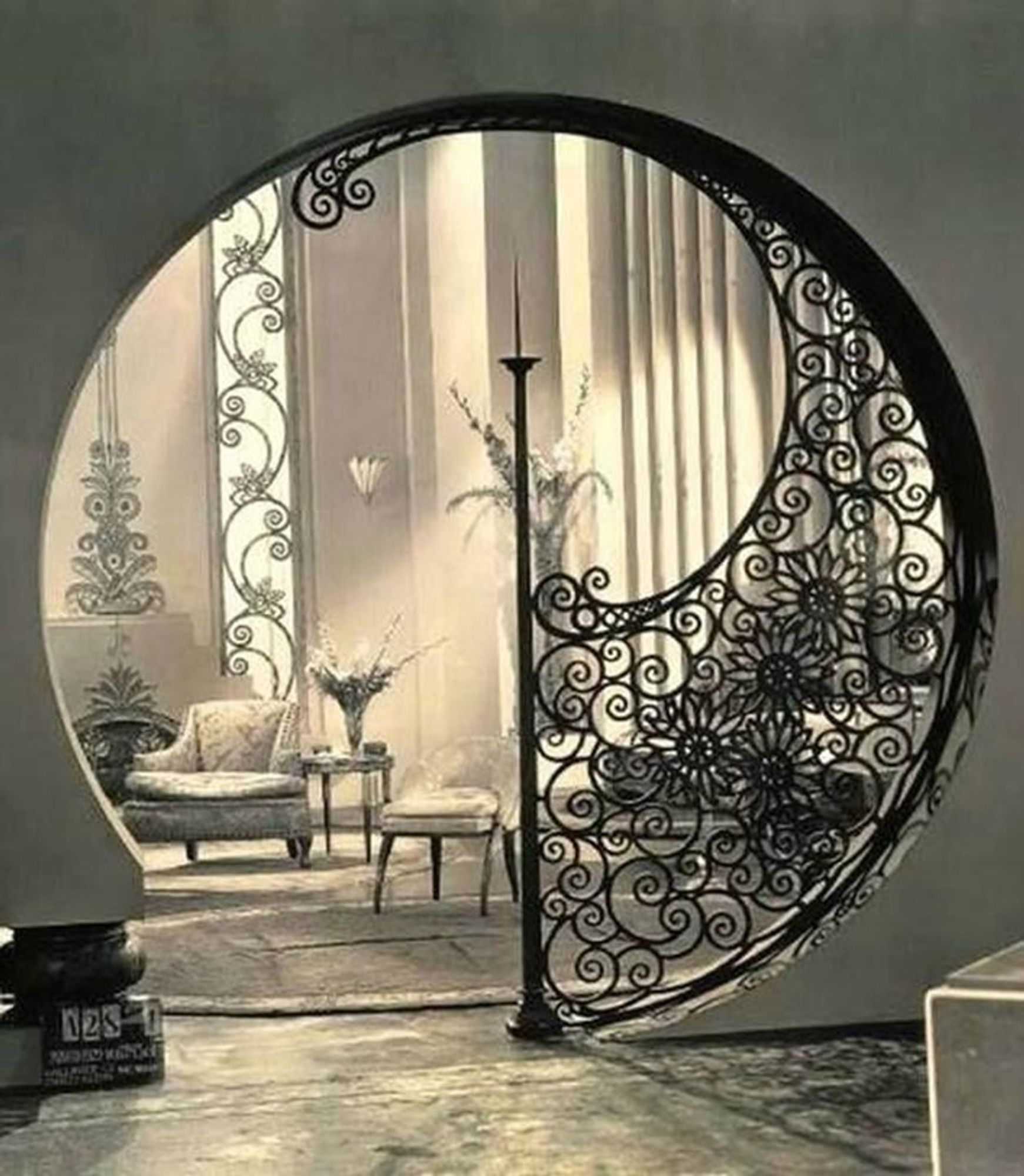 Round entranceway to sumptuous living room, partly framed with decorative ironwork