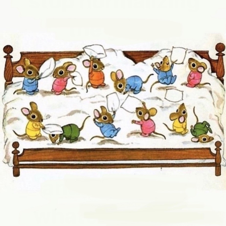 colorful mice playing on a large bed