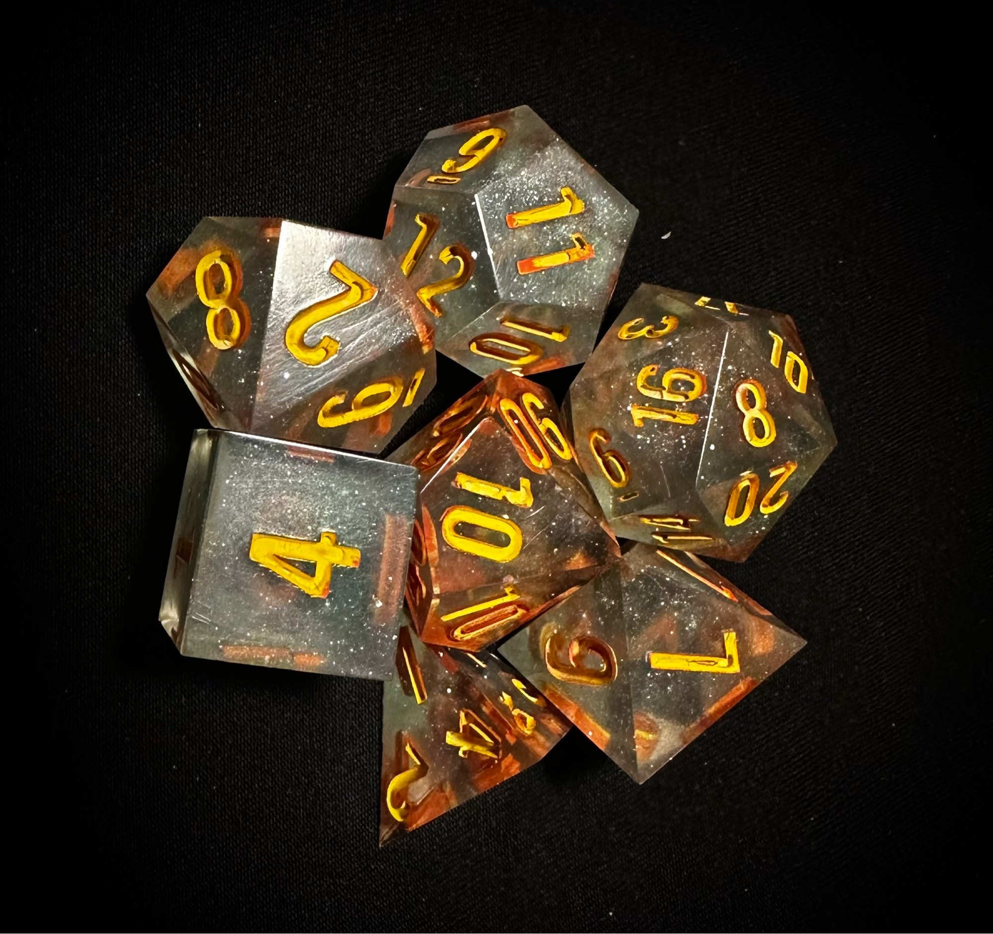 Sparkly blue set of dice inked in yellow and orange