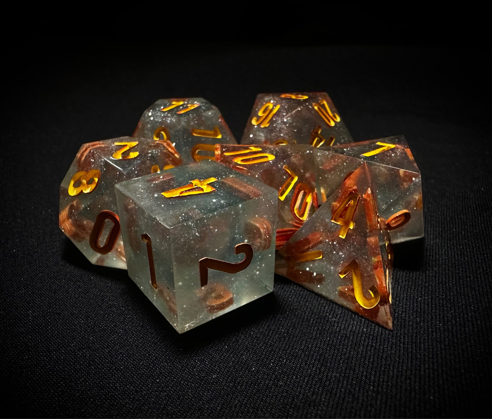 Sparkly blue set of dice inked in yellow and orange