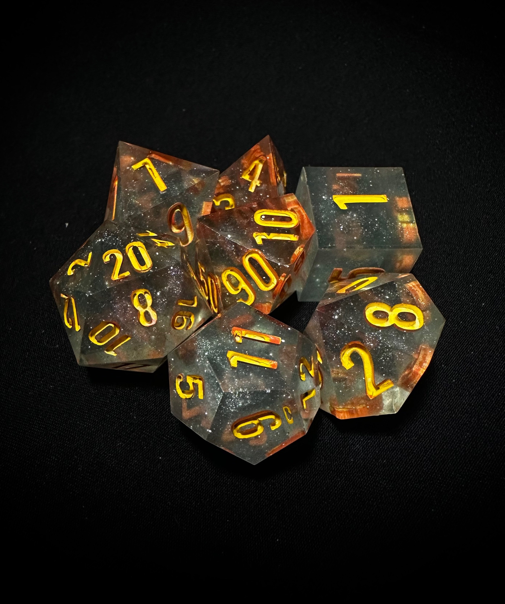 Sparkly blue set of dice inked in yellow and orange