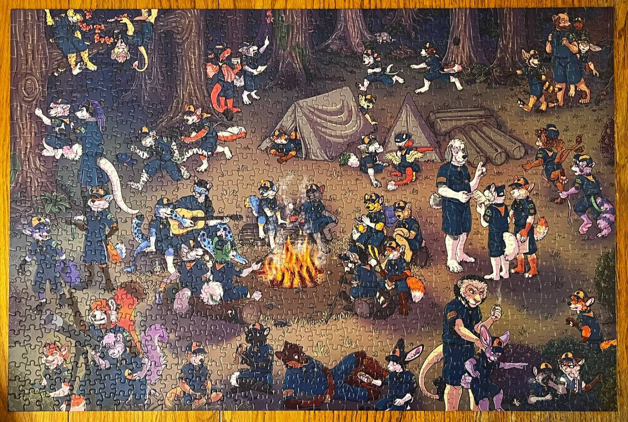 The Cub Scout Campout finished puzzle. The illustration shows 47 different furries participating in activities the Cub Scouts do. Such as looking up at the stars with a telescope, setting up the tents, carving their own derby cars from wood, getting into trouble by smoking in the bushes and climbing trees, sitting around the campfire telling stories, singing and cooking food, playing Flag Tag, and on a Scavenger Hunt. There are even two micro furry fox characters hidden in the image somewhere.