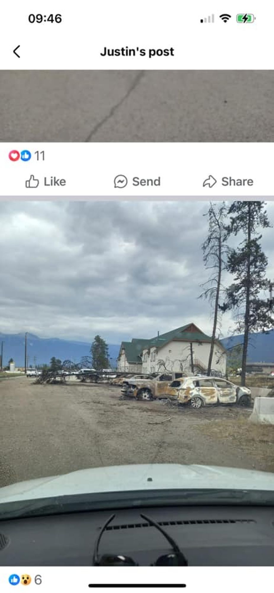 Photo of the CN Bunkhouse in Jasper, shown as safe, with very visible burned cars in the front