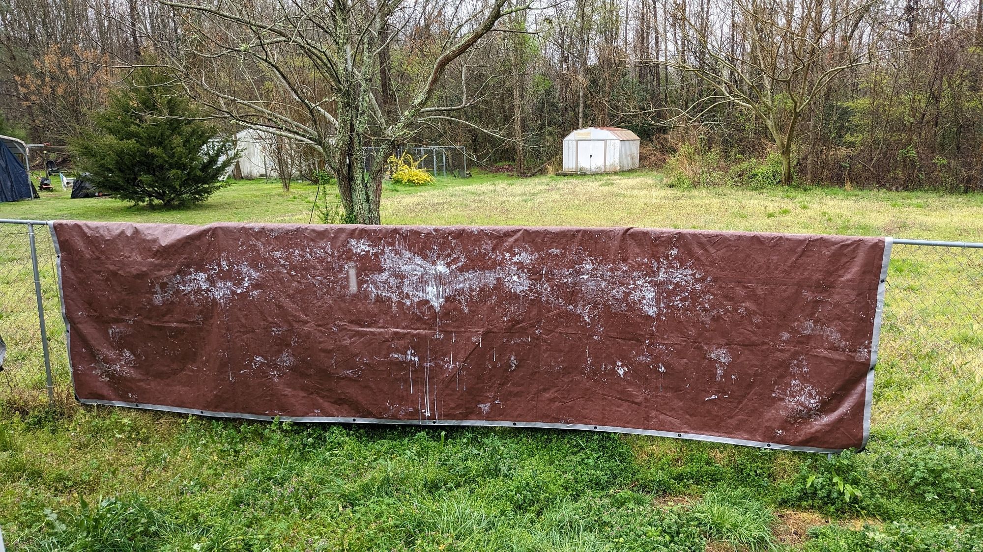 Tarp hanging over a fence that looks like the Staypuff Marshmallow Man was given the Dexter treatment