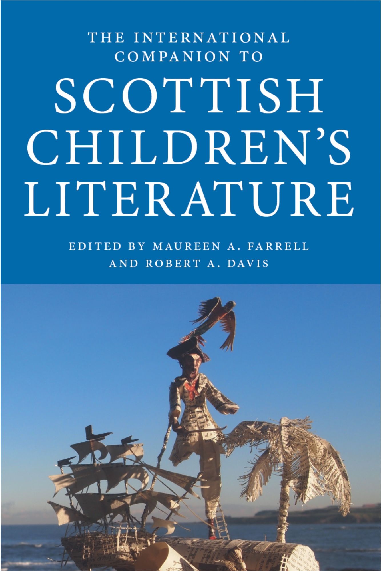 Book cover: The International Companion to Scottish Children’s Literature
Edited by Maureen A. Farrell and Robert A. Davis

Image: against a blue sky, a paper sculpture made from printed book pages of a sailing ship, a one-legged pirate, a palm tree and a treasure chest