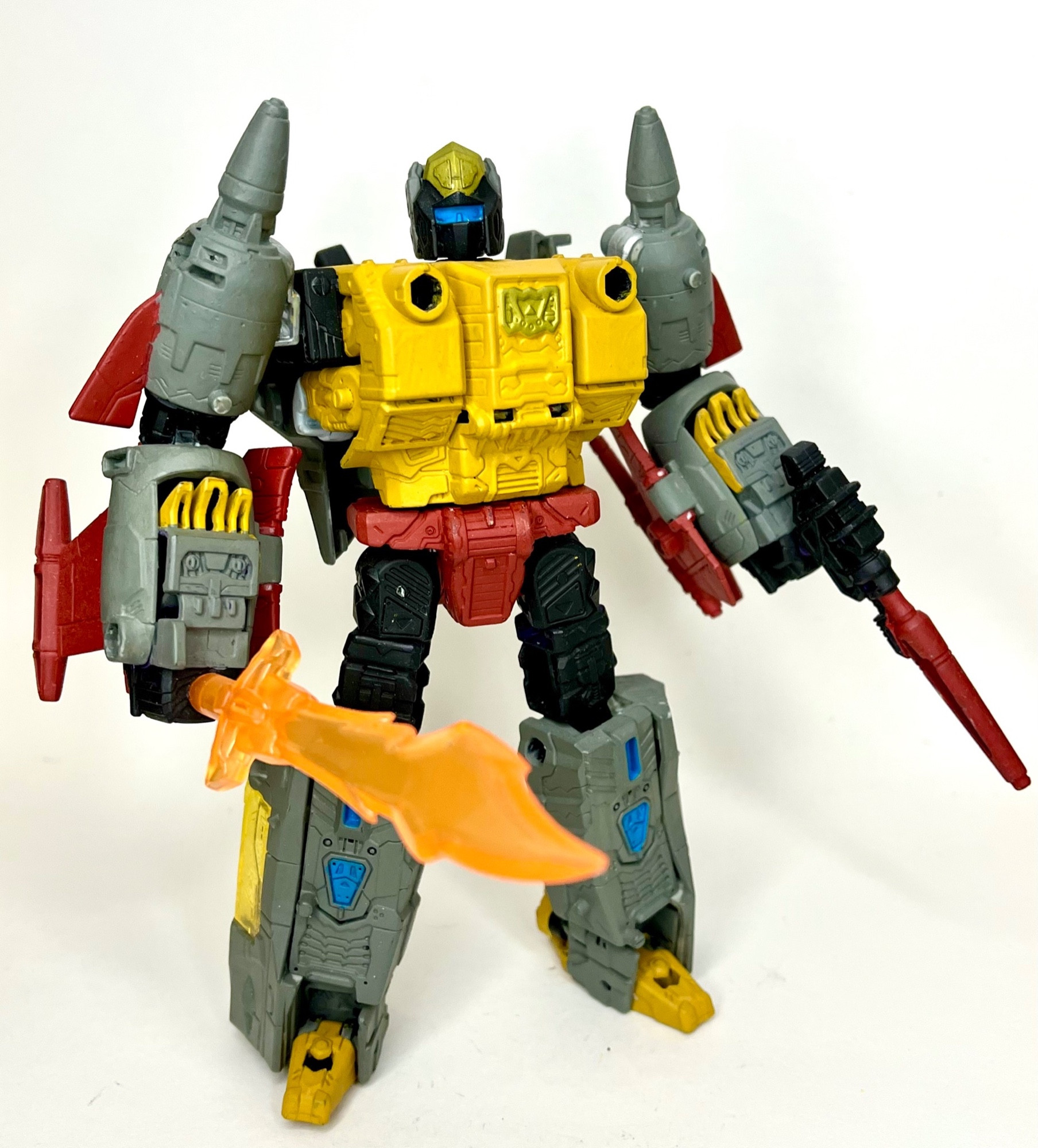 An Earthrise Snapdragon custom painted into Grimlock, bot mode, holding one gun and a flame sword 