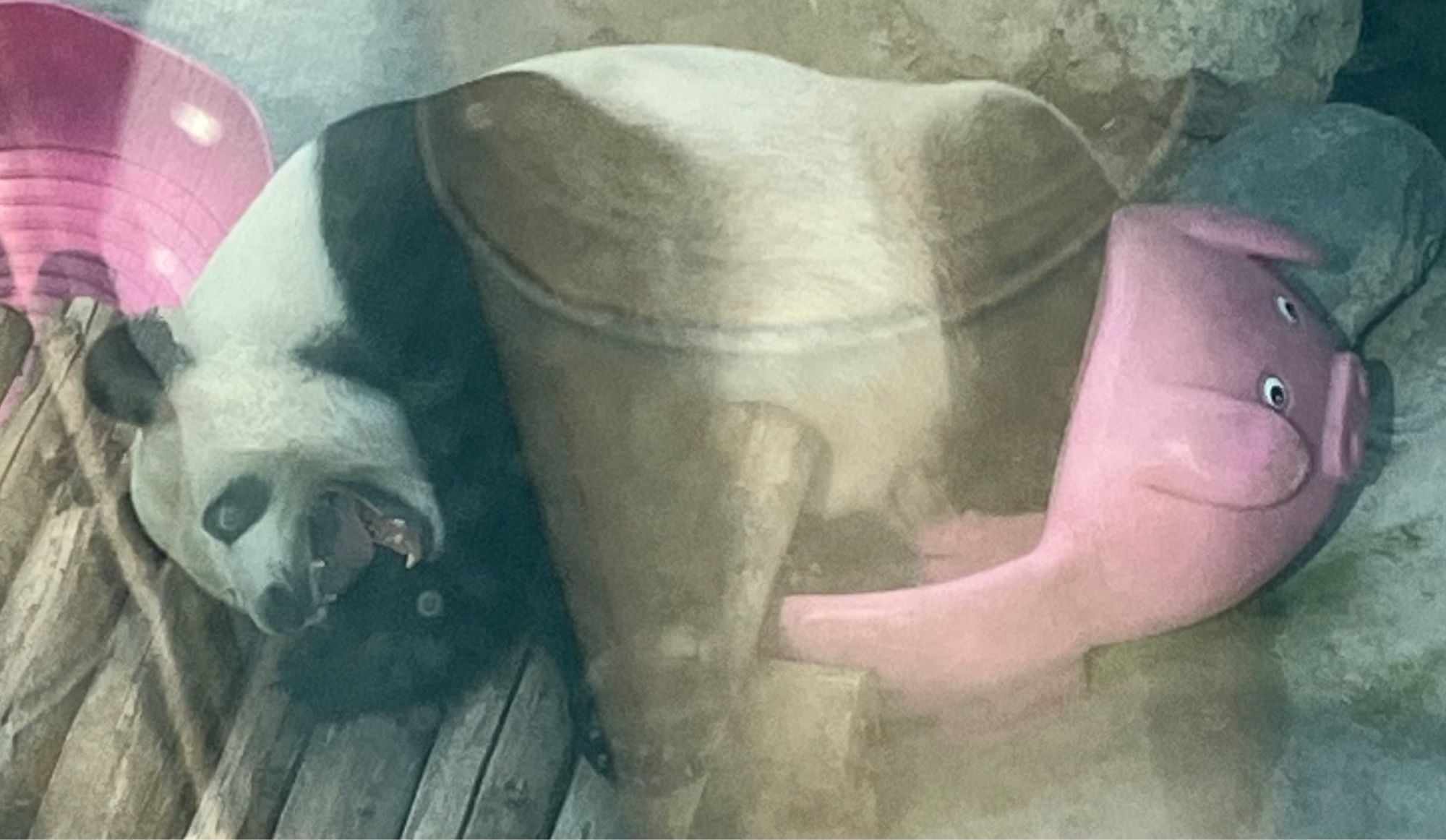 Very hot panda lying (weirdly) in a pink toy bath shaped like a cartoon pig. In the captive breeding program.