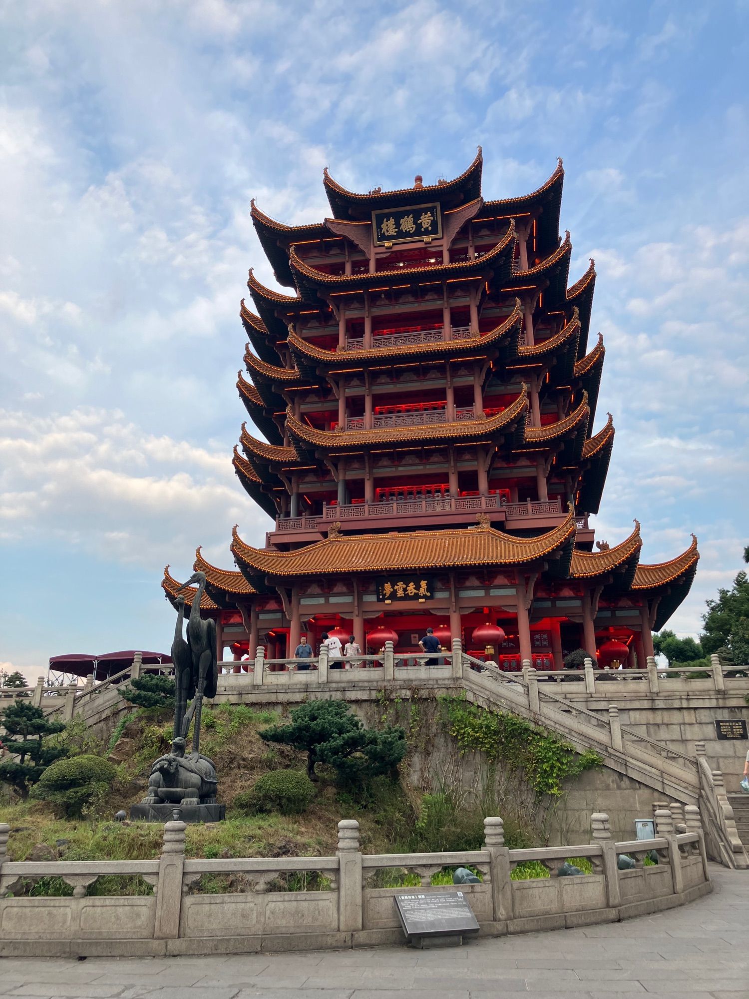 Large pagoda type tower with 4 balconies, yellow tiled roof. This is Yellow Crane Tower.