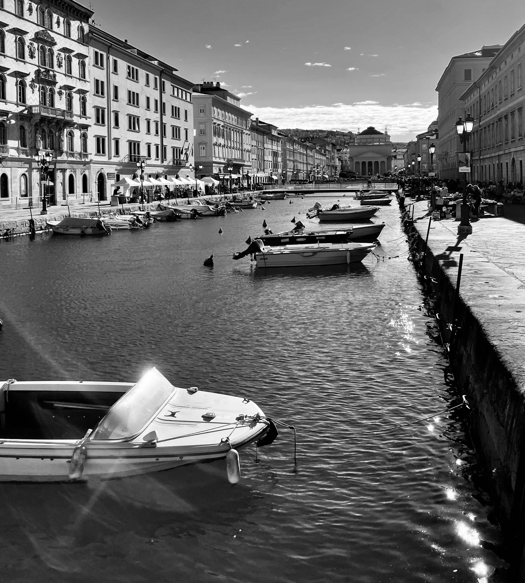 Another view of the Grand Canal in Trieste with the sun sparkling off the moored boats.