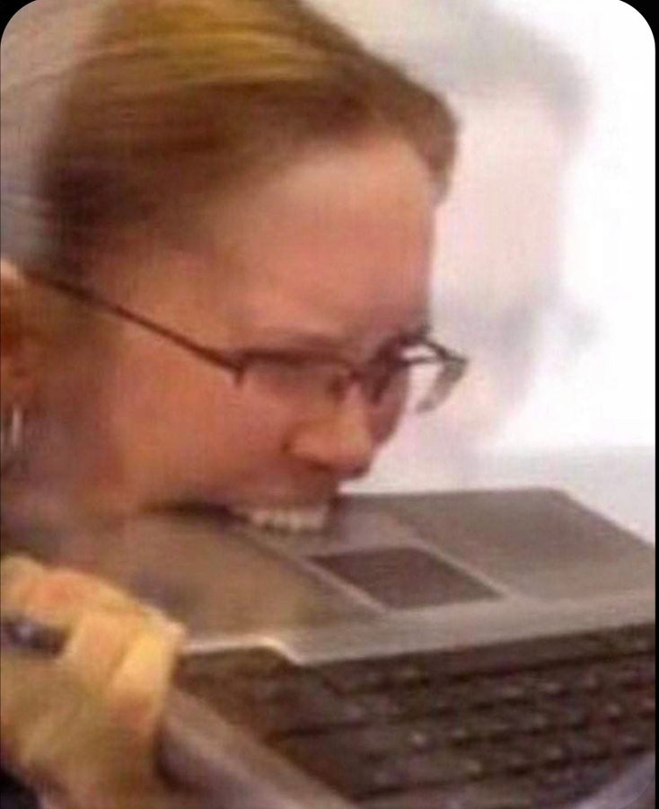 Woman with glasses biting laptop reaction meme