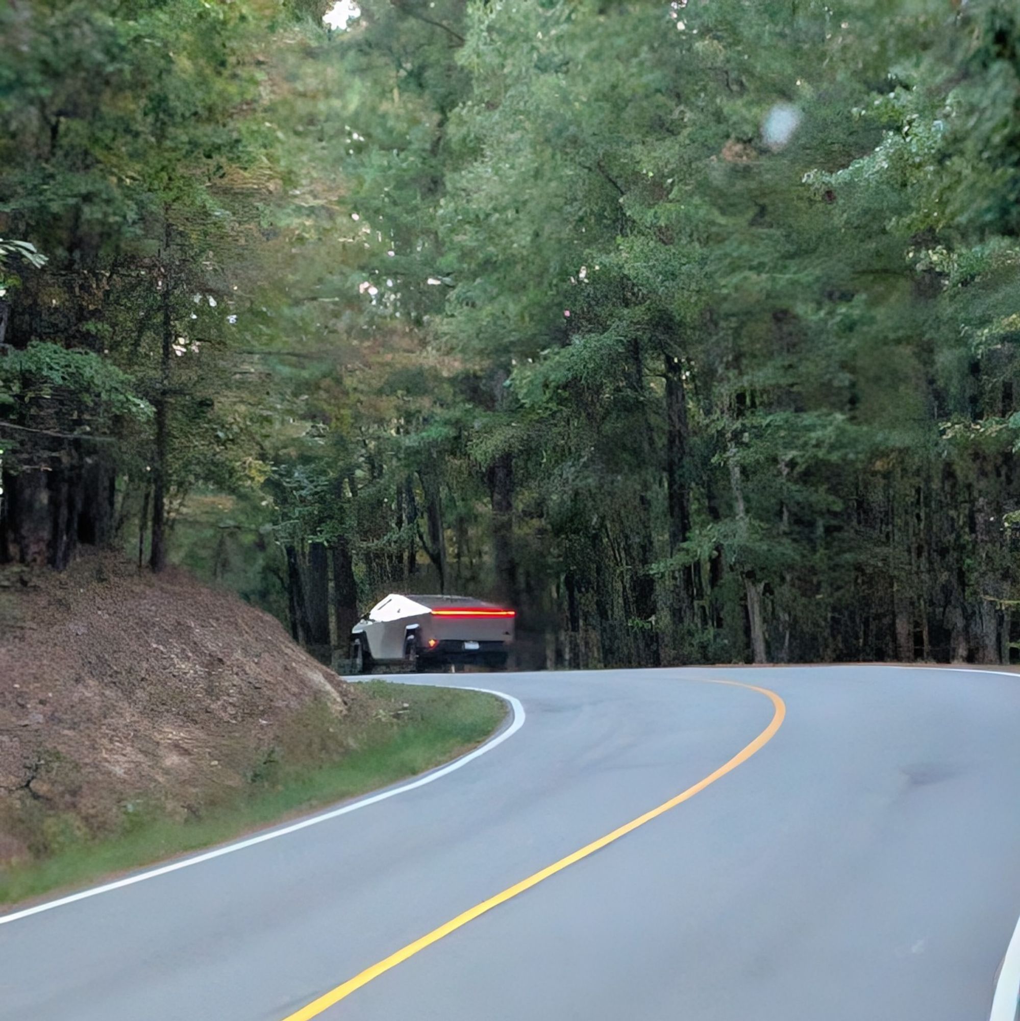 Cyber truck on forested back road