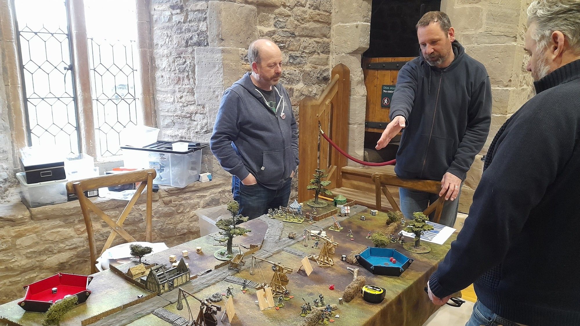 The table set for the Ecorchurs 14yh century siege game, with buildings, trees  men at arms and siege engines