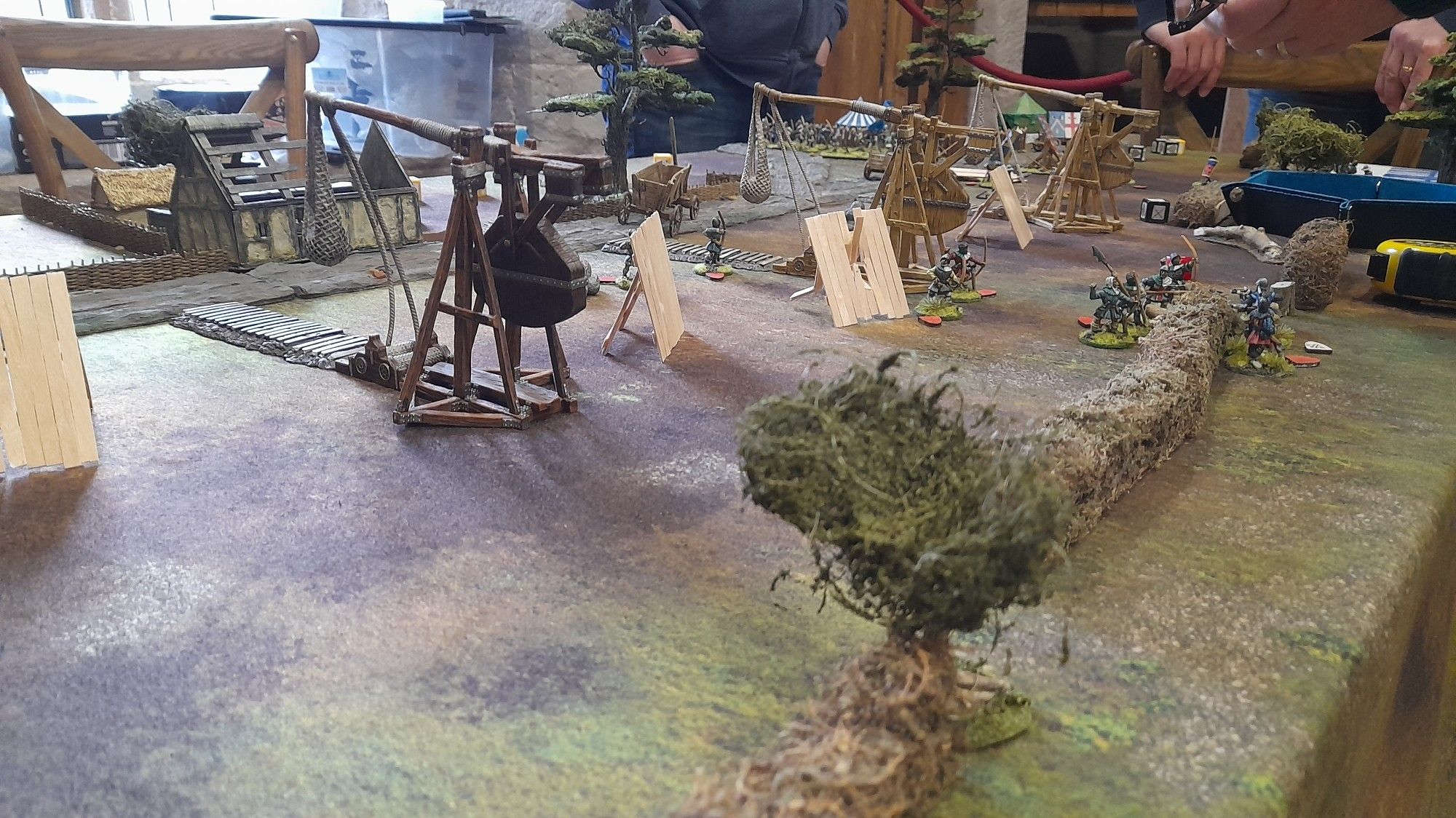 Miniature trebuchet siege engines ready to fire