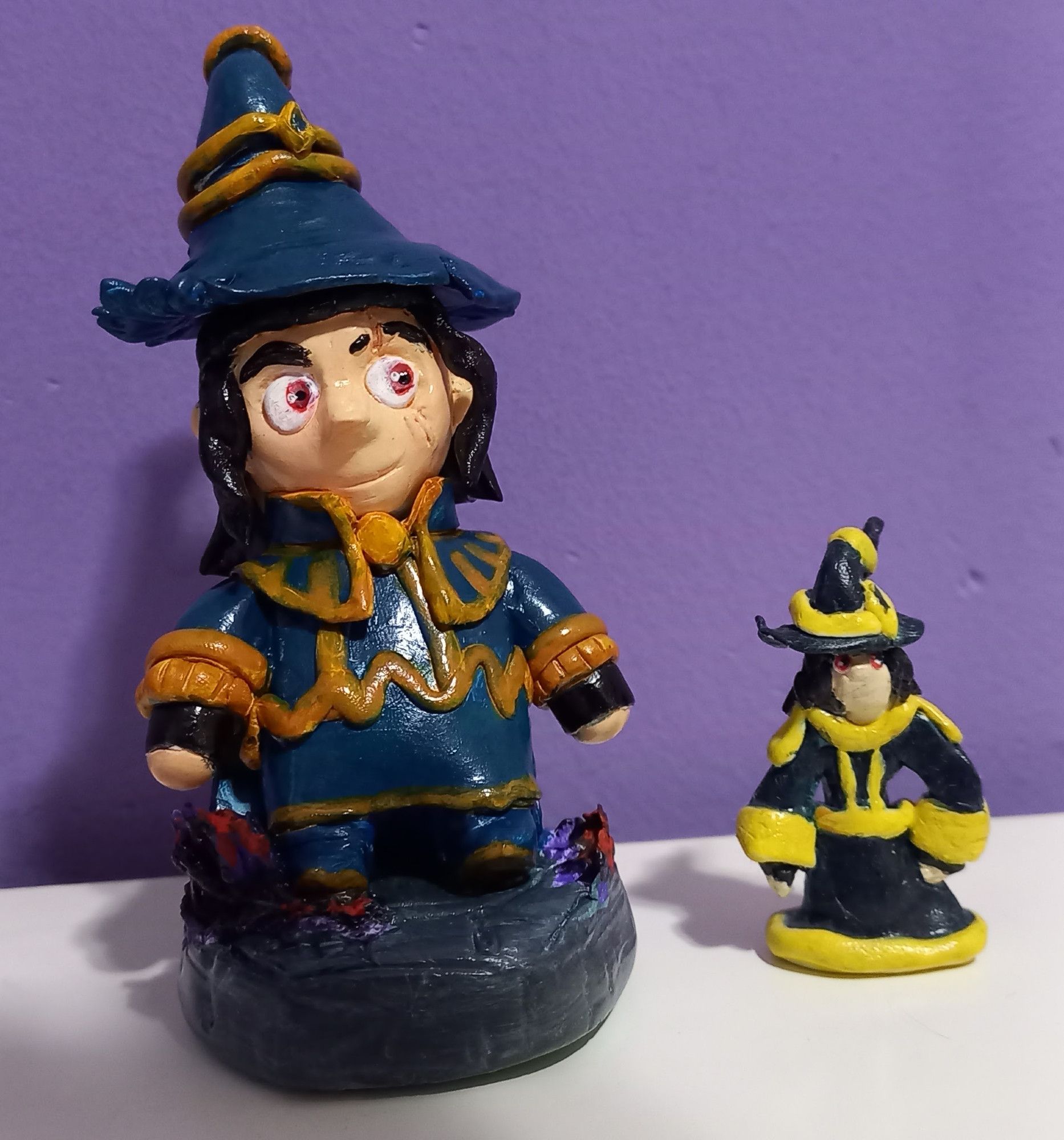 Picture of clay figures of the wizard Mortimer from the webcomic Splitting Image, with a tiny, rough oven baked figure and a much newer, bigger and detailed air dry version.