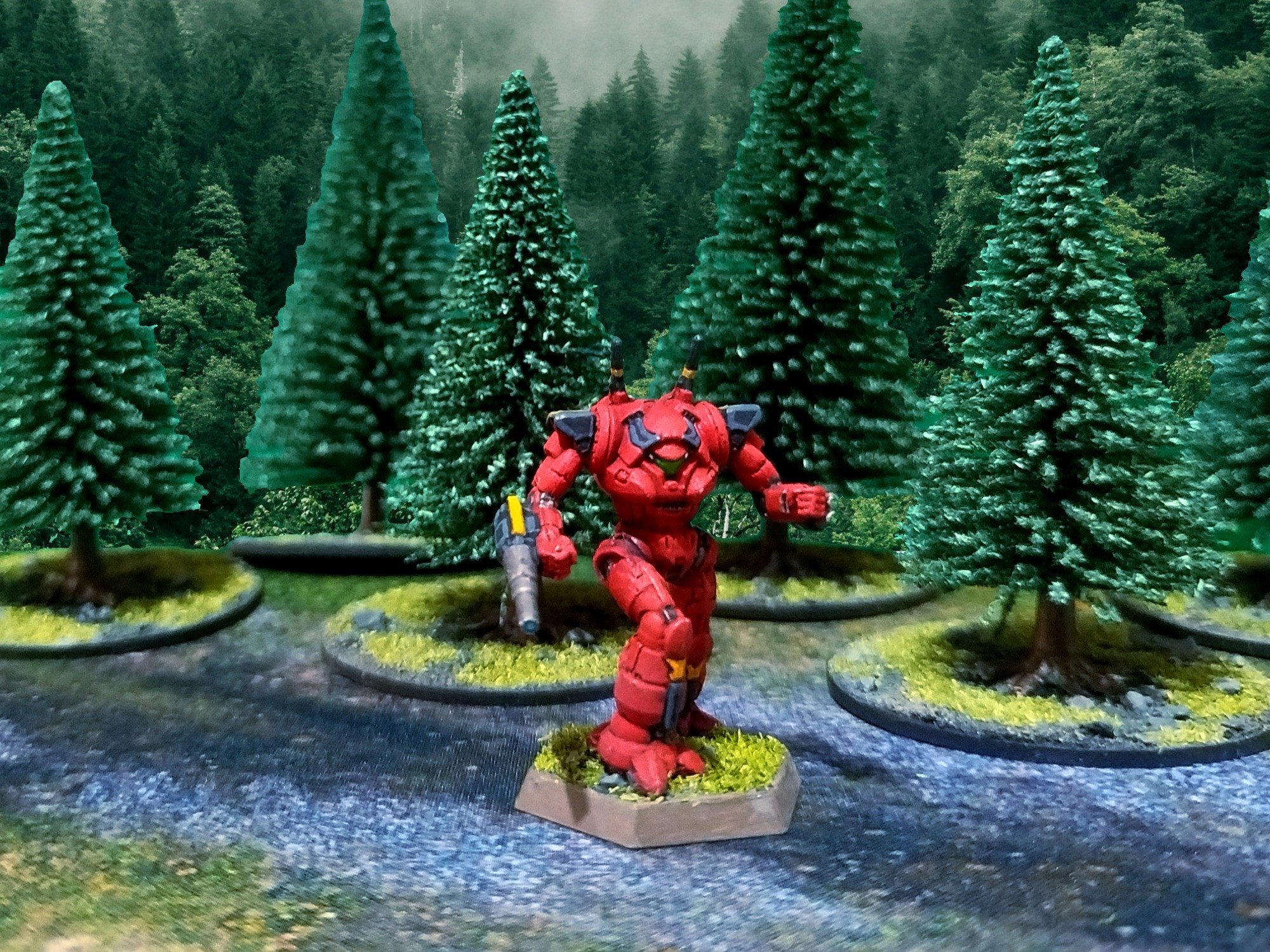 Foto de un diorama de una miniatura de un mecha clase Wraith de Battletech avanzando por un camino a través de un bosque de pinos.

Se trata de un mecha de silueta humanoide con 2 antenas en la espalda y una cabina que recuerda a un casco samurái. Va armado con un Láser Grande de Pulso en su brazo derecho y dos Láseres Medios de Pulso en su brazo izquierdo.

Está pintado de color rojo con acentos de color negro y amarillo.
