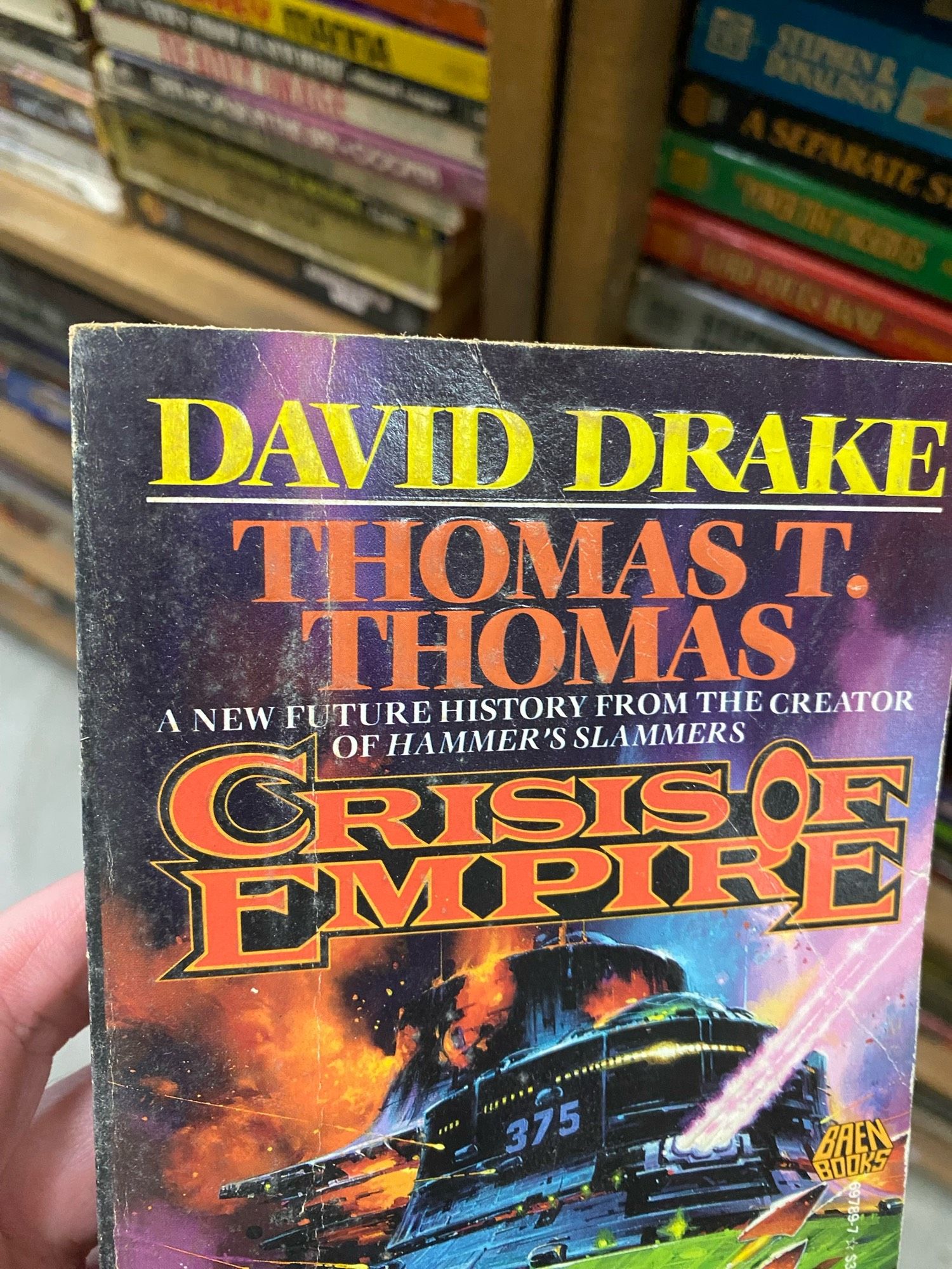 Book cover:

A SETARATE S
DAVID DRAKE
THOMAS T.
THOMAS
A NEW FUTURE HISTORY FROM THE CREATOR OF HAMMER'S SLAMMERS
CRISI OF EMPIRE