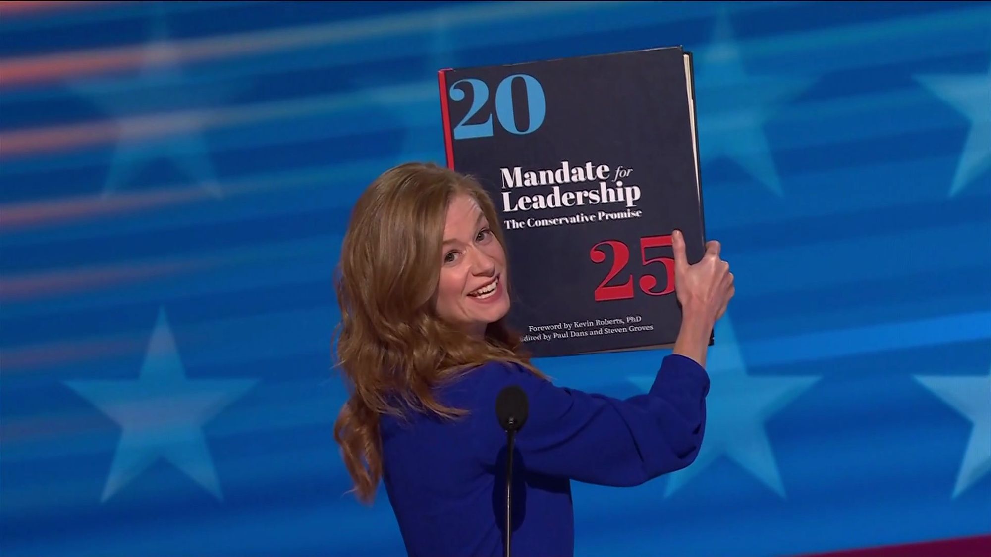 Mallory McMorrow holding a gigantic volume that is Project 2025