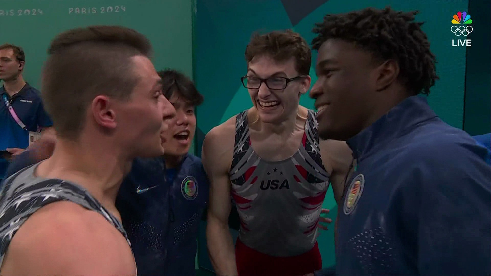 the u.s. men's gymnastics team. the gentleman in back has glasses and is making a very dorky face