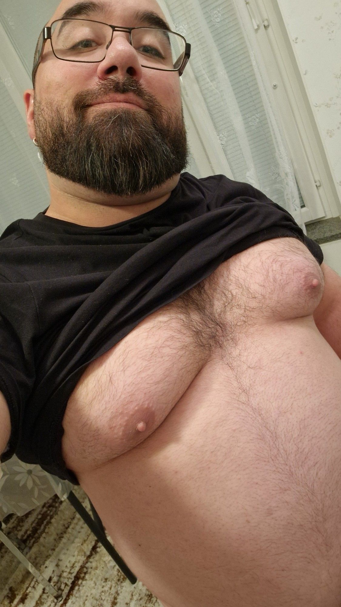 In my kitched, black t-shirt hiked up to over my tits.