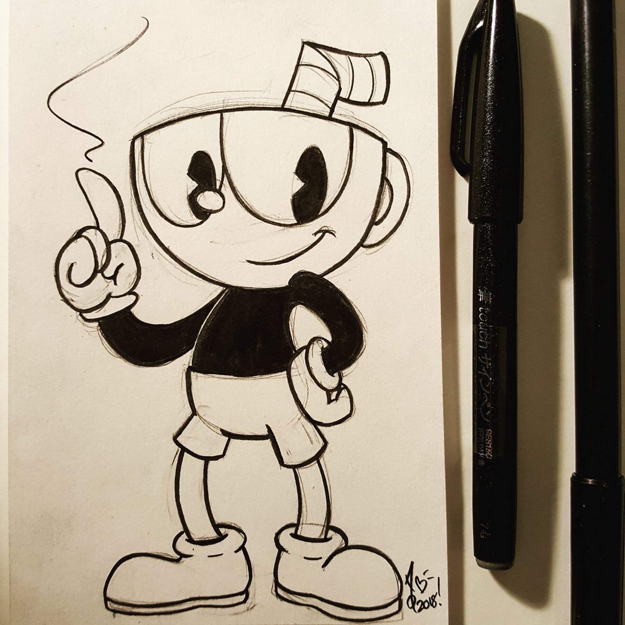 a photo of a cuphead drawing i did on an index card, pencil lines still visible below inked line art. cuphead is standing with his hand on his hip and smoke coming off the tip of his finger (which is used a as a gun in game). the pens i used to ink it are on the side.