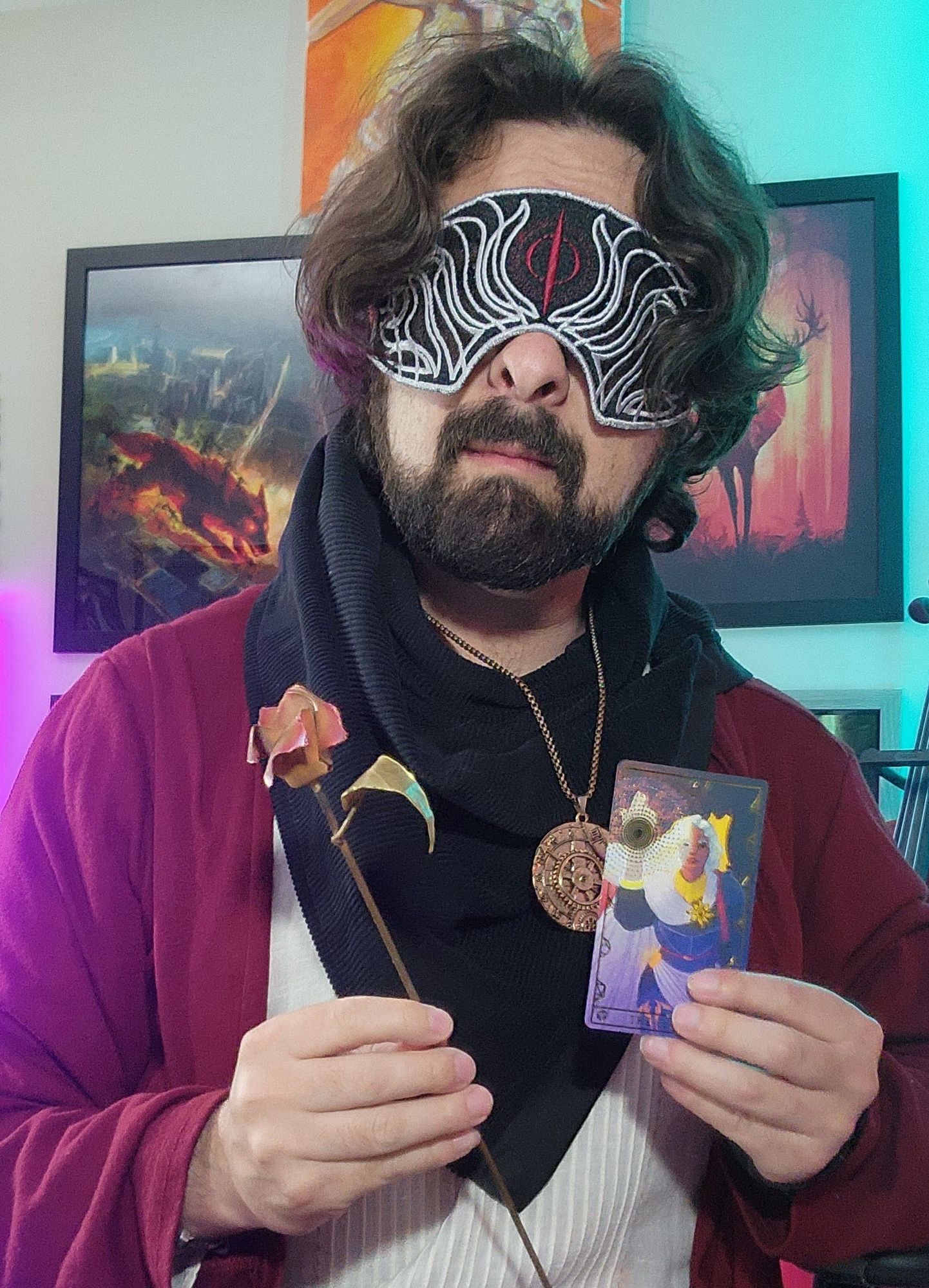 Arat holding a metal rose and the Cleric card from the Wild Oracle deck