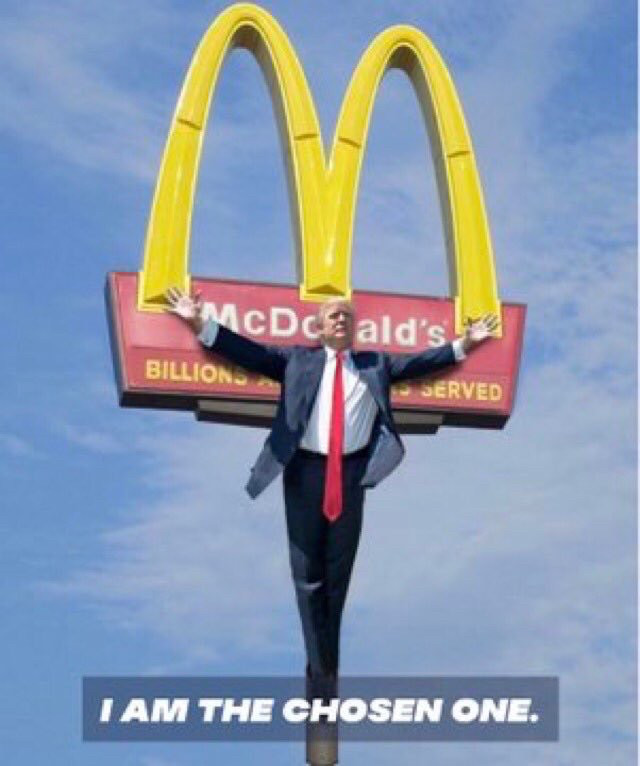 Donald Trump spread eagle like he's being crucified on a McDonald's golden arches sign, below it is says "I'm the chosen one" an actual Trump quote 