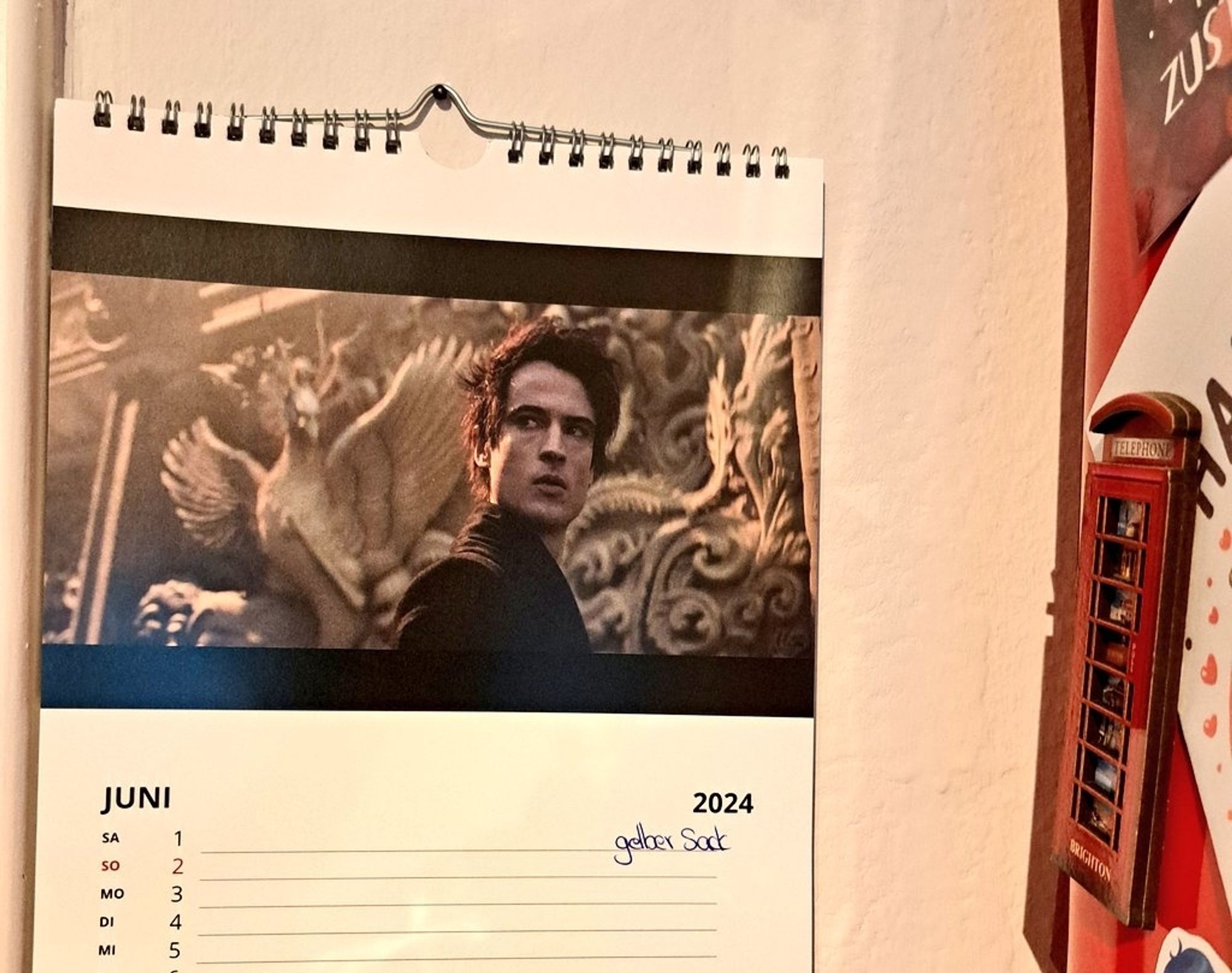 Picture of a wall calendar with the current month of June and a picture of the main character from the 'The Sandman' show.