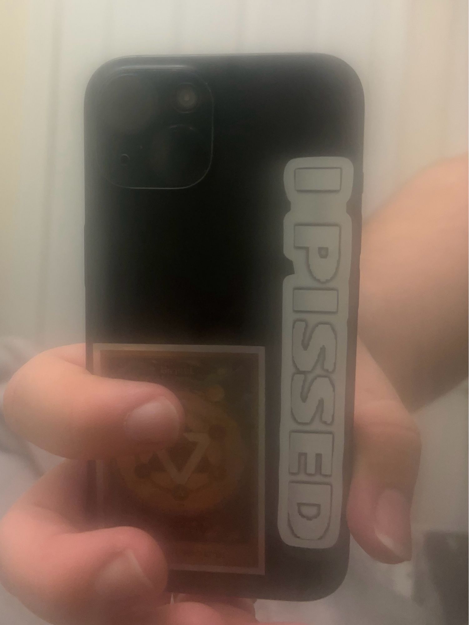 iPhone 15 with a I Pissed sticker