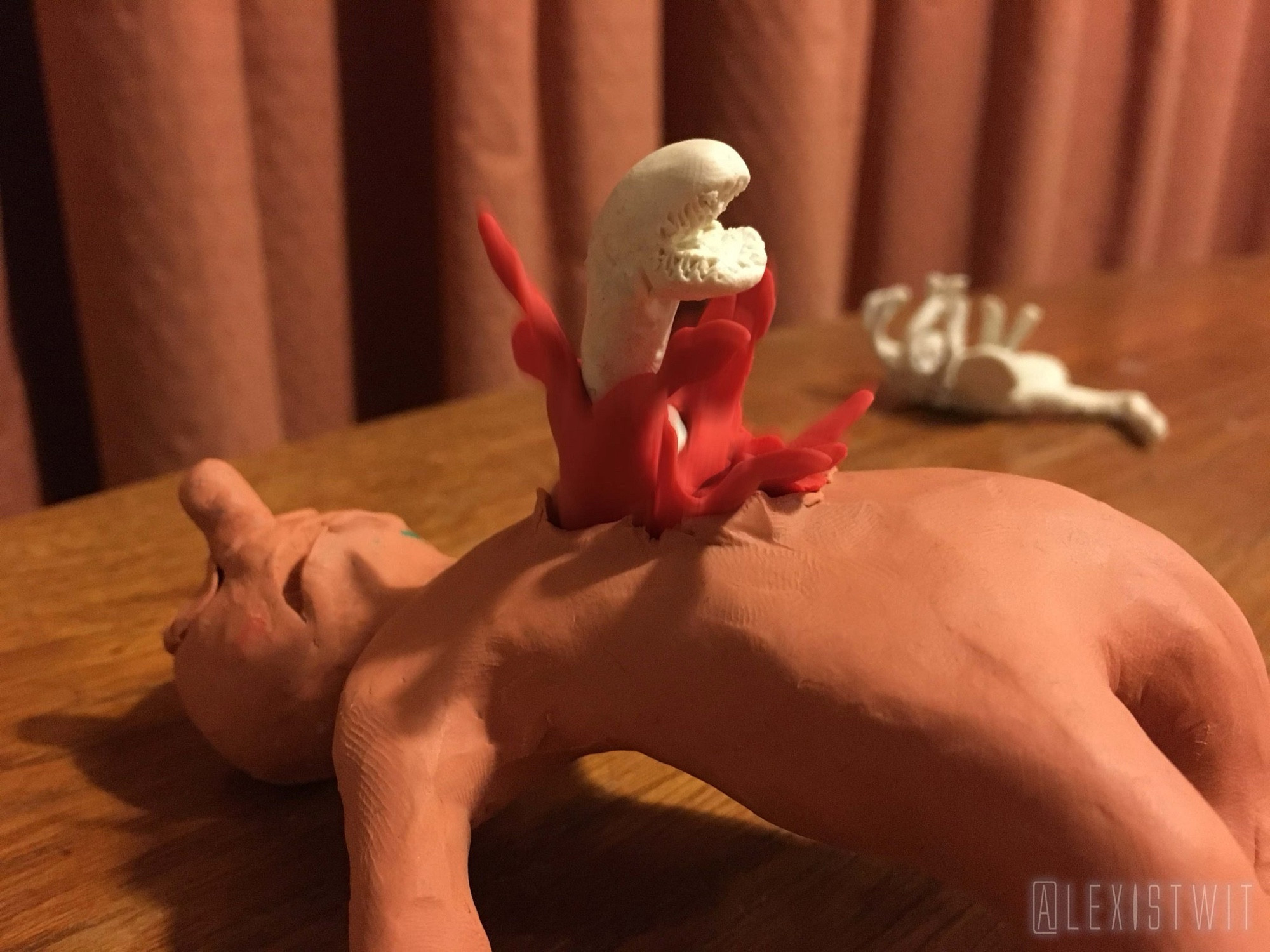 Released from the facehugger, which now lies motionless in the background, Morph’s back arches in agony as a toothy snakelike abomination bursts out of his chest in a fountain of bright red plasticine gore