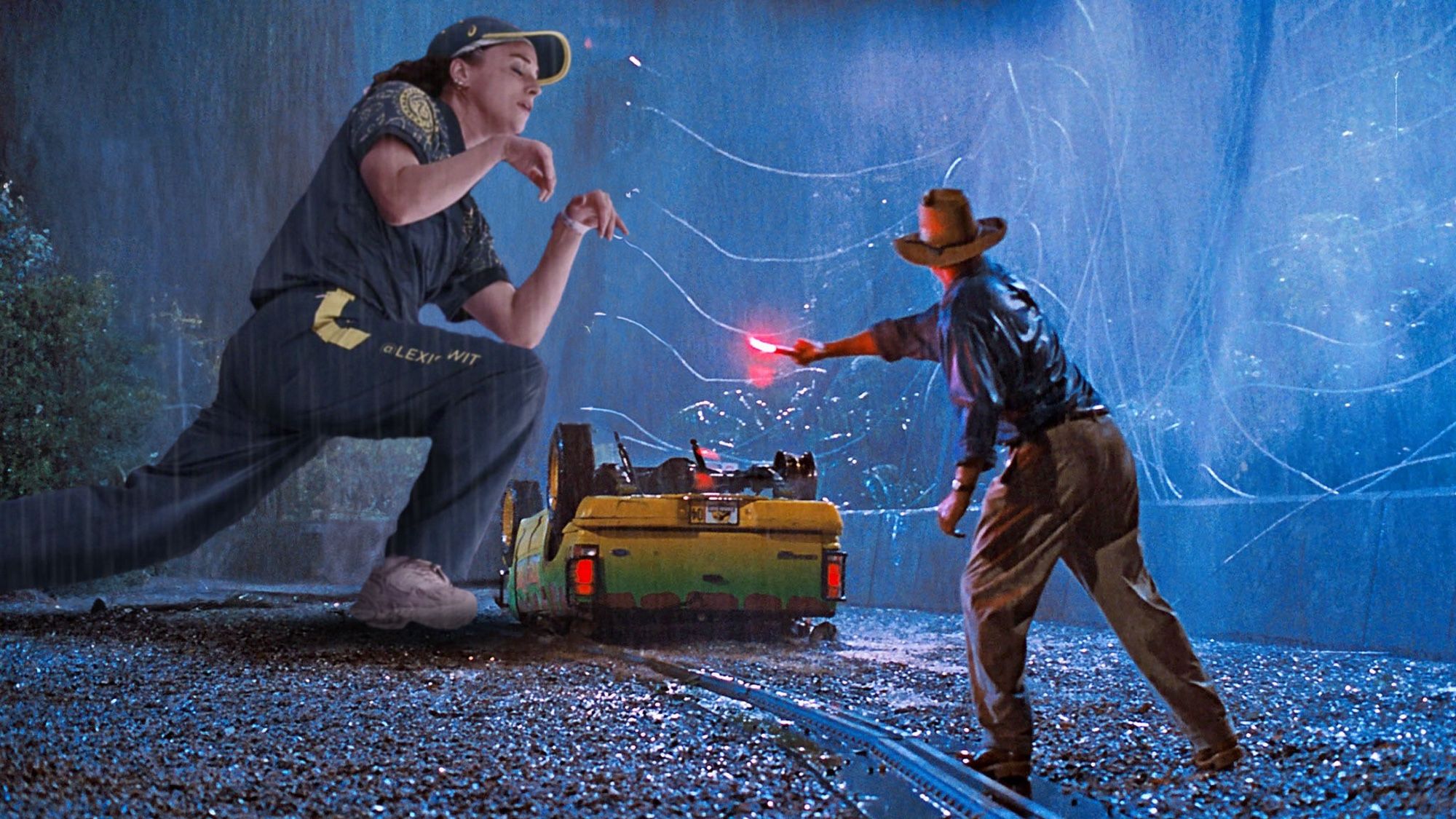 Sam Neil as Alan Grant in Jurassic Park, standing in the rain next to an overturned jeep, waving a flare at a gigantic prancing Rachael ‘Raygun’ Gunn