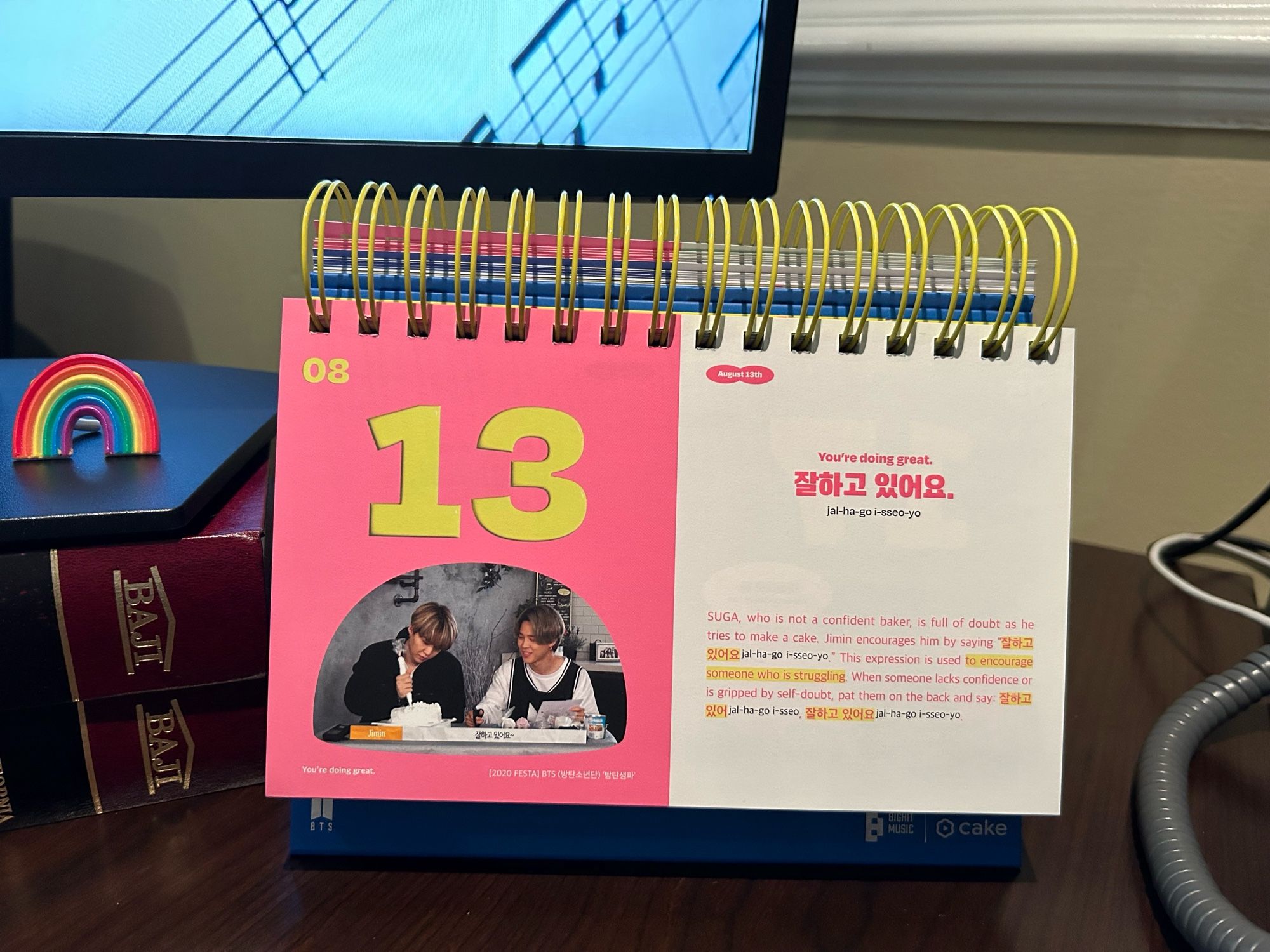 August 13 on BTS’ English perpetual calendar. 

Shows Yunki and Jimin. Yunki is decorating a cake and struggling. Jimin cheers him on by saying, “잔하고 있어요.“