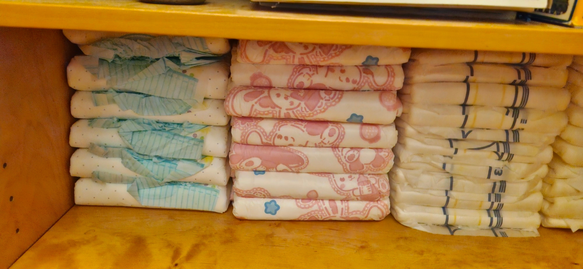 Inside of Zoe's closet, one side is full of colourful printed nappies