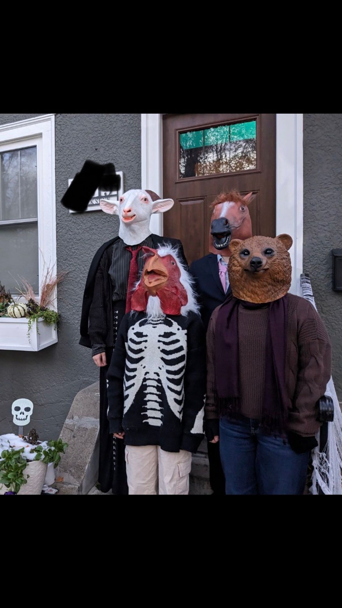 4 kids in animal head masks.  A goat, a chicken, a horse, and a bear