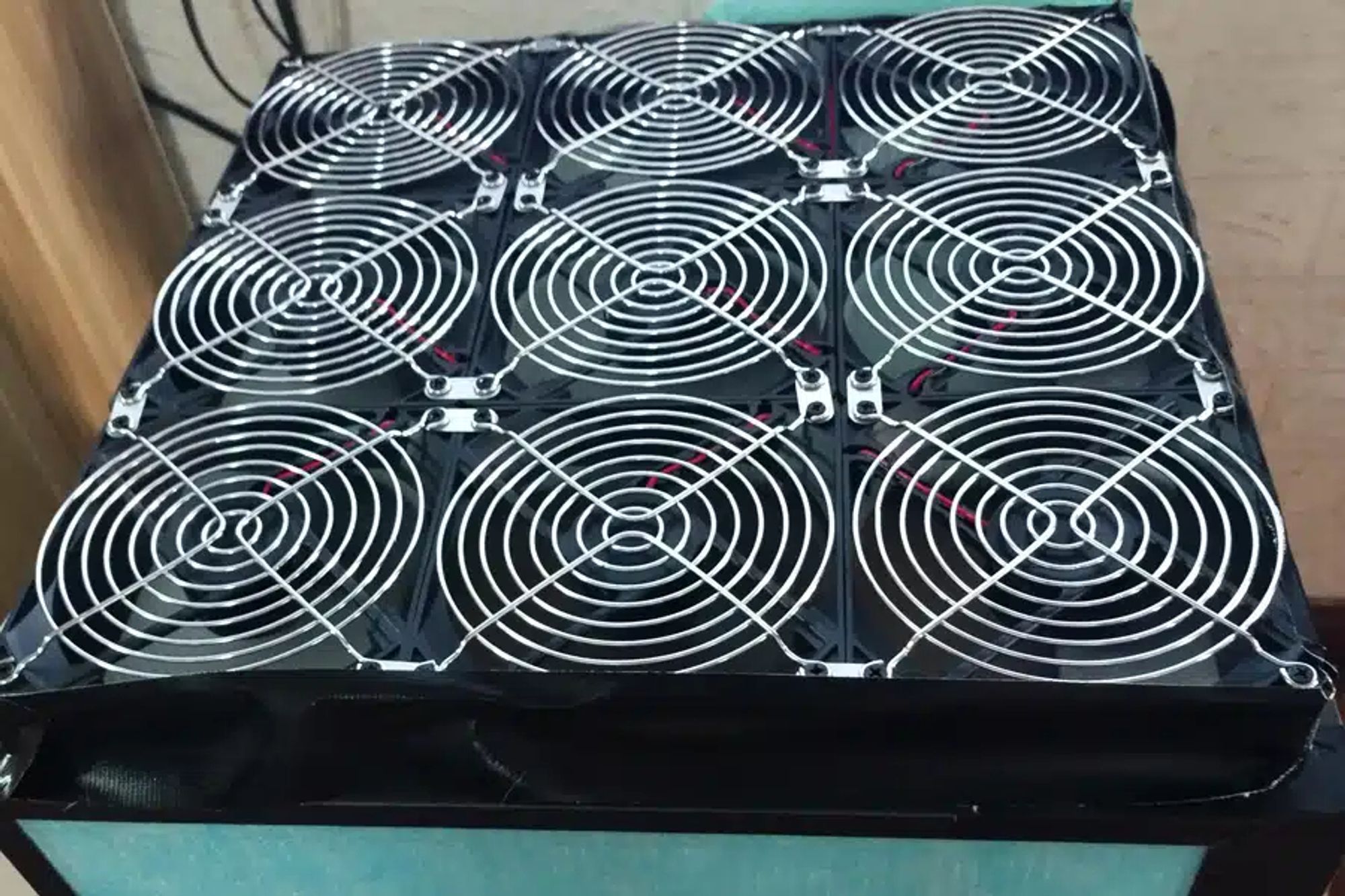 9 140mm pc fans connected in a grid attached to a box made of hepa filters