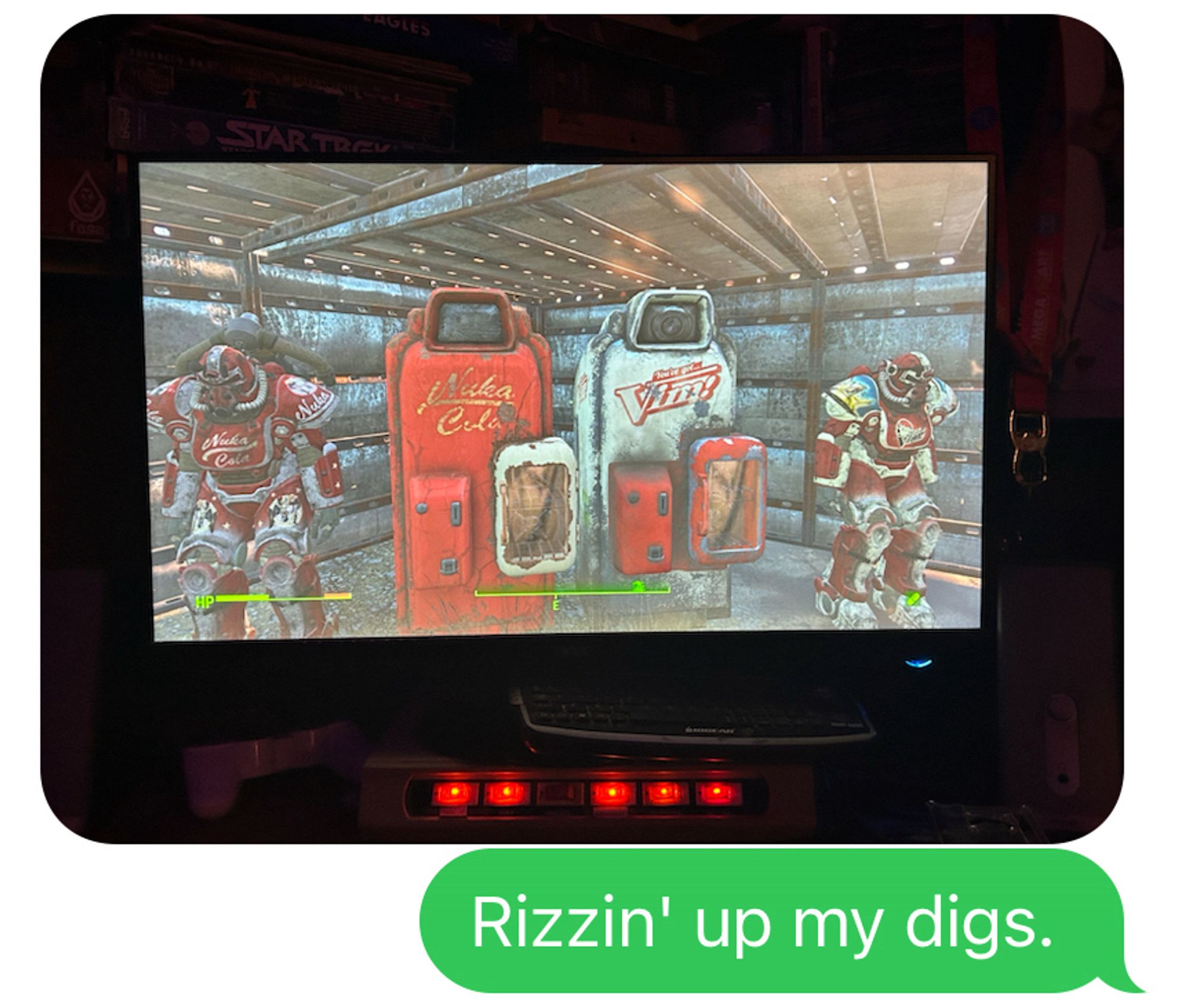 Screen shot from the Fallout 4 game depicting two sets of power armor next to two in-game soda machines. A text message beneath the picture says “Rizzin’ up my digs”.