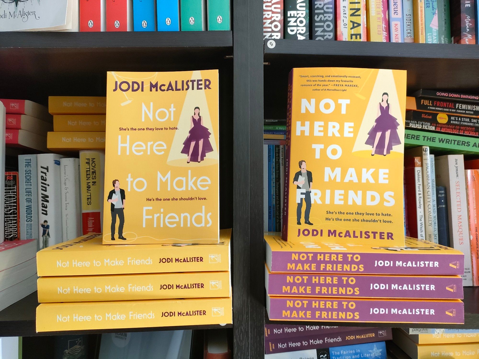 The Australian and US editions of Not Here To Make Friends. They're both yellow cartoon cover romcoms. The US spine is purple.