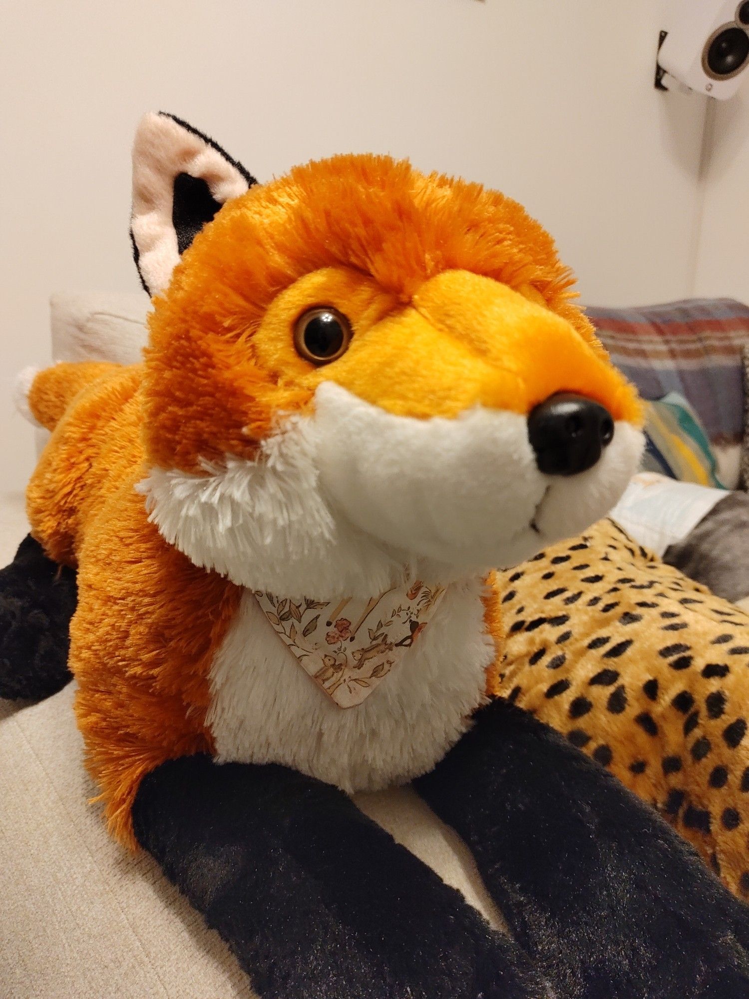 Plushie fox wearing a bandana.