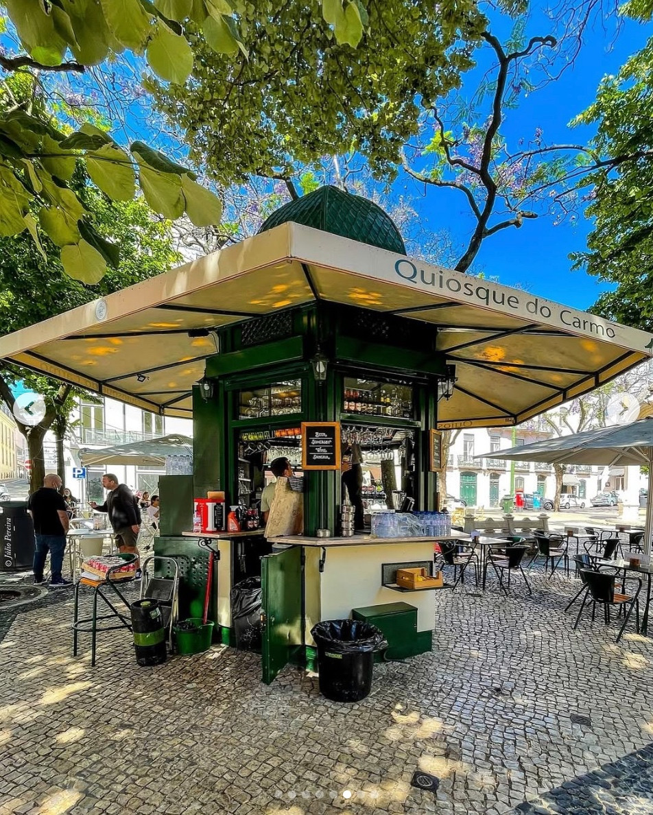 a little coffee kiosk in a park in lisbon portugal adds charm, convenience, and vibrancy to the public space