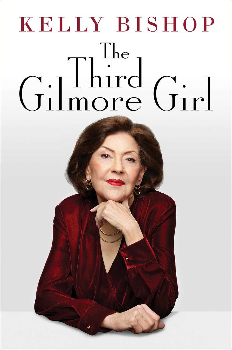 Book cover: The Third Gilmore Girl by Kelly Bishop.

Kelly Bishop in a red shirt smiles lightly as she sits at a white table with her hand under her chin.