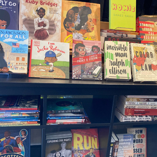 Display of books for Black History Month at Booksweet. Visible are "To Boldly Go," a picturebook about Nichelle Nichols; "Justice for All," a picturebook about Justice Ketanji Brown Jackson; the picturebooks "I am Ruby Bridges" and "I am Jackie Robinson;" "Coretta," a picturebook about Coretta Scott King; "History Comics: Rosa Parks & Claudette Colvin;" "Invisible Man" by Ralph Ellison; "Homie" by Danez Smith; "The Color of Law" by Richard Rothstein; and others.