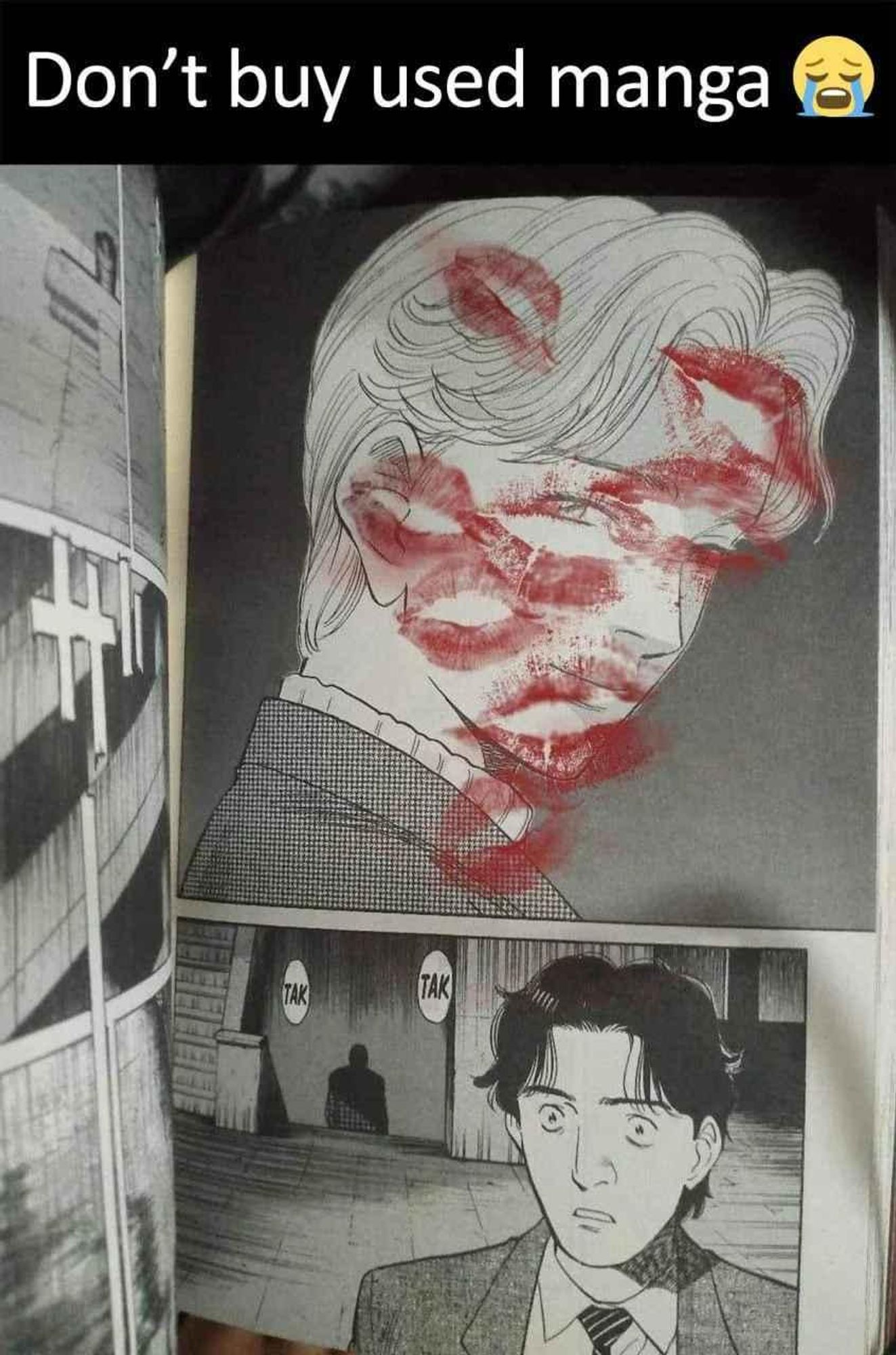 a photograph of a page from naoki urosawa's monster with a half-paged sized panel containing johan liebert's portrait covered in lipstick prints, captioned "don't buy used manga 😭"