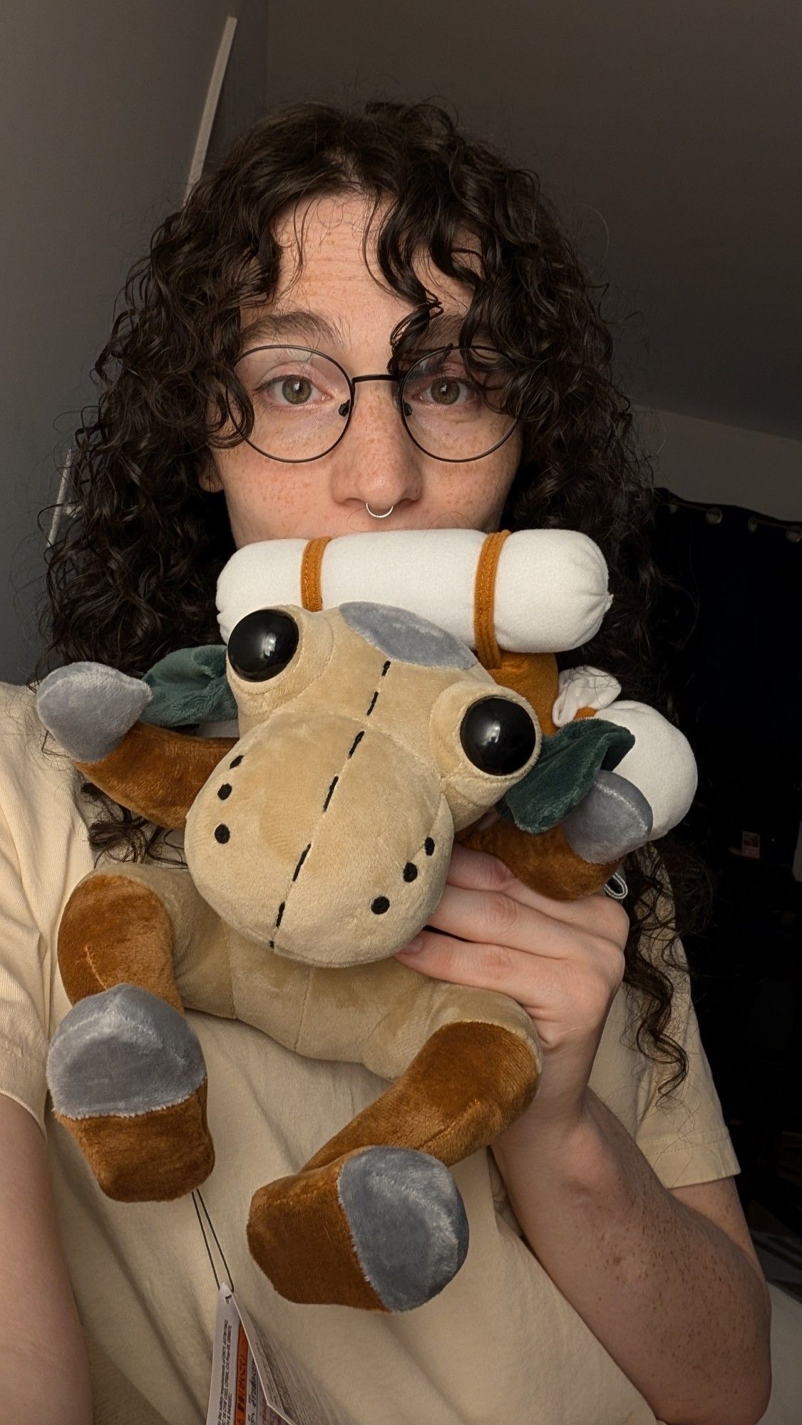 bee holding a plushie of a goblin from ffxi