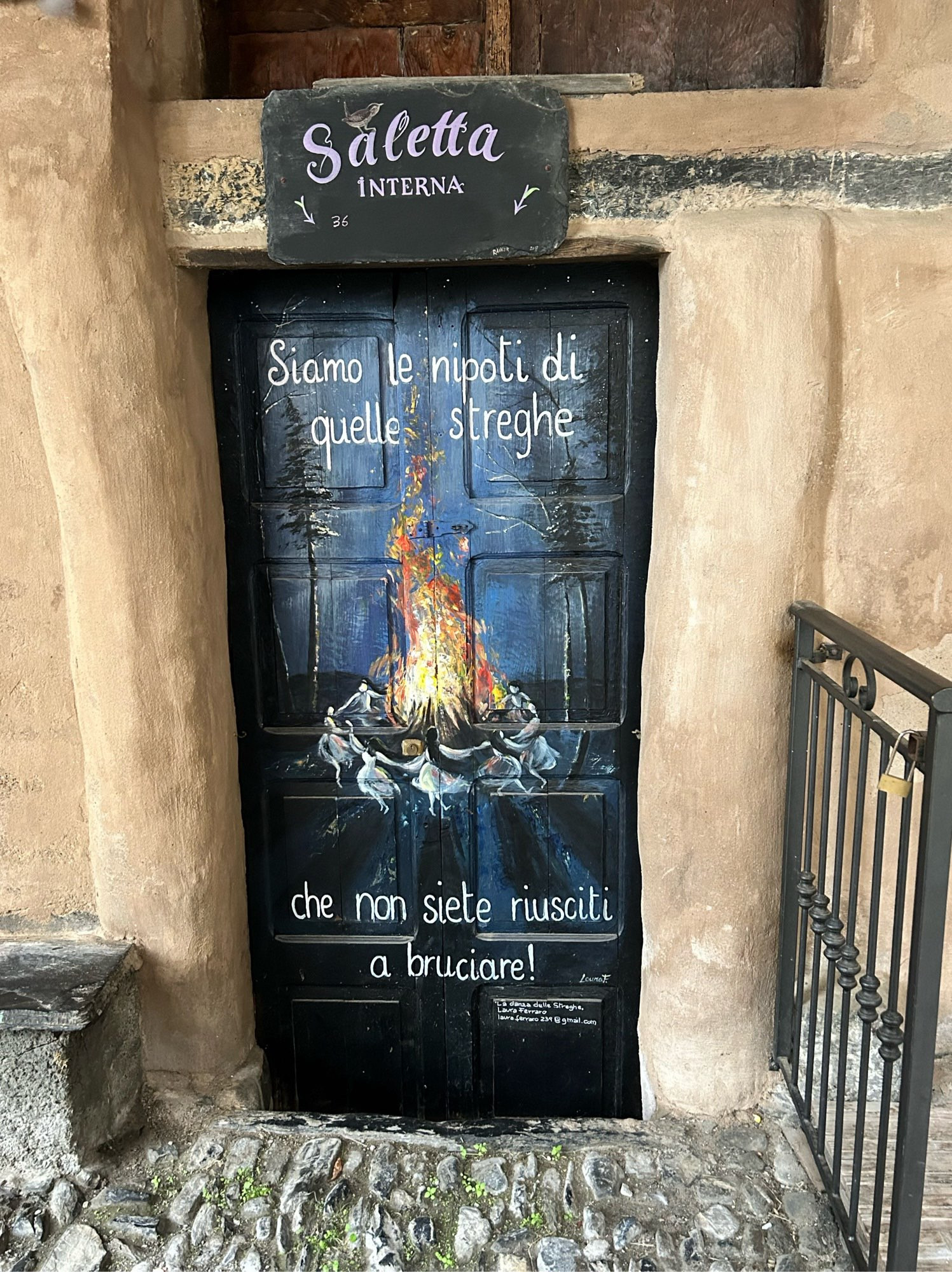 More local art in Triora: a door with a picture of witches dancing round a fire and the text Siamo le nipoti di quelle streghe che non siete riusciti a bruciare! (Were the grandchildren of the witches they couldn’t burn)