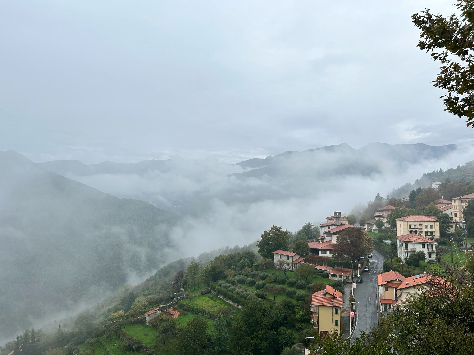 View from the village of triora over the mist shrouded valley below and houses