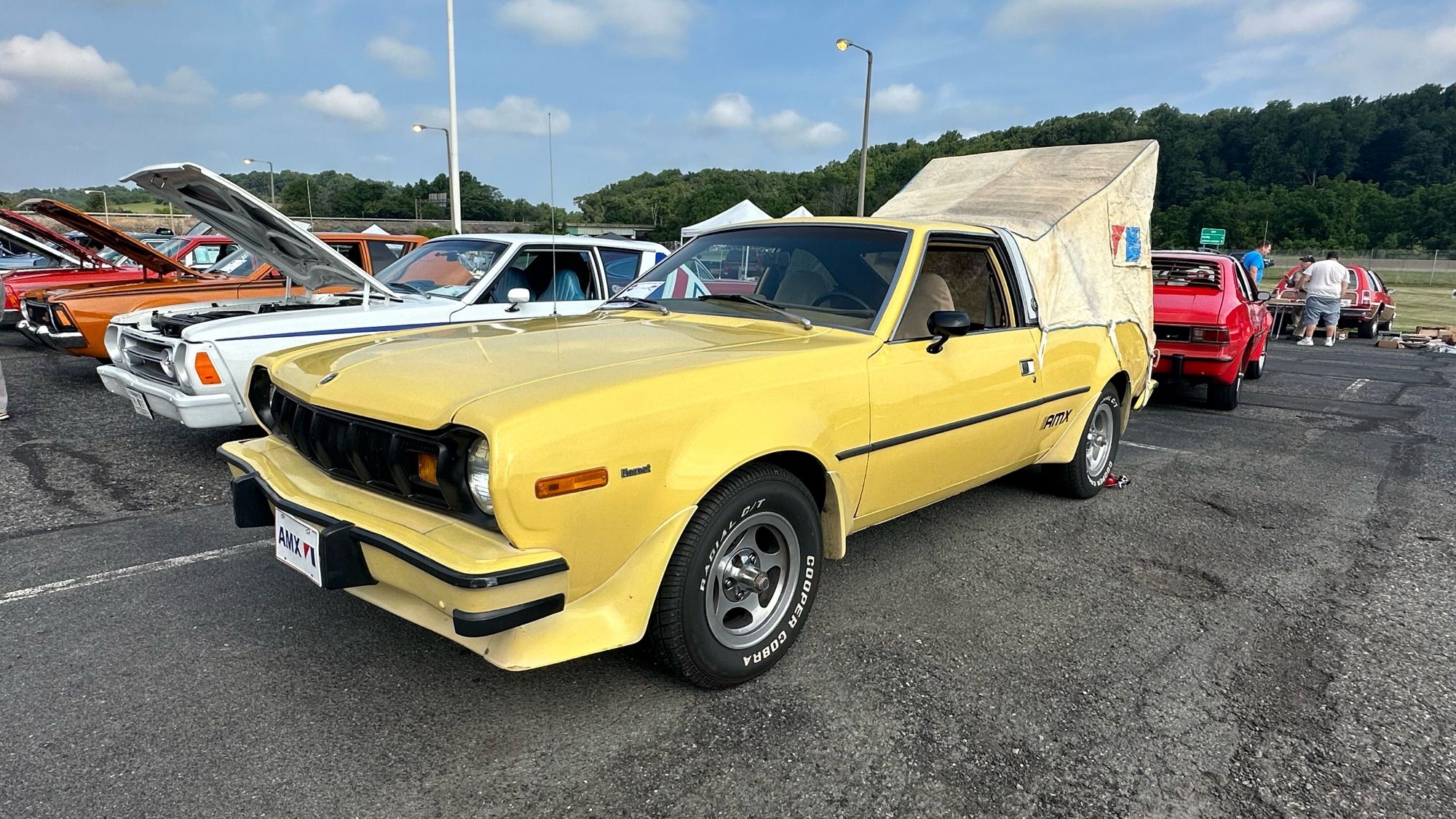 Photo of a yellow Hornet AMX with the factory option rear hatch tent set up.