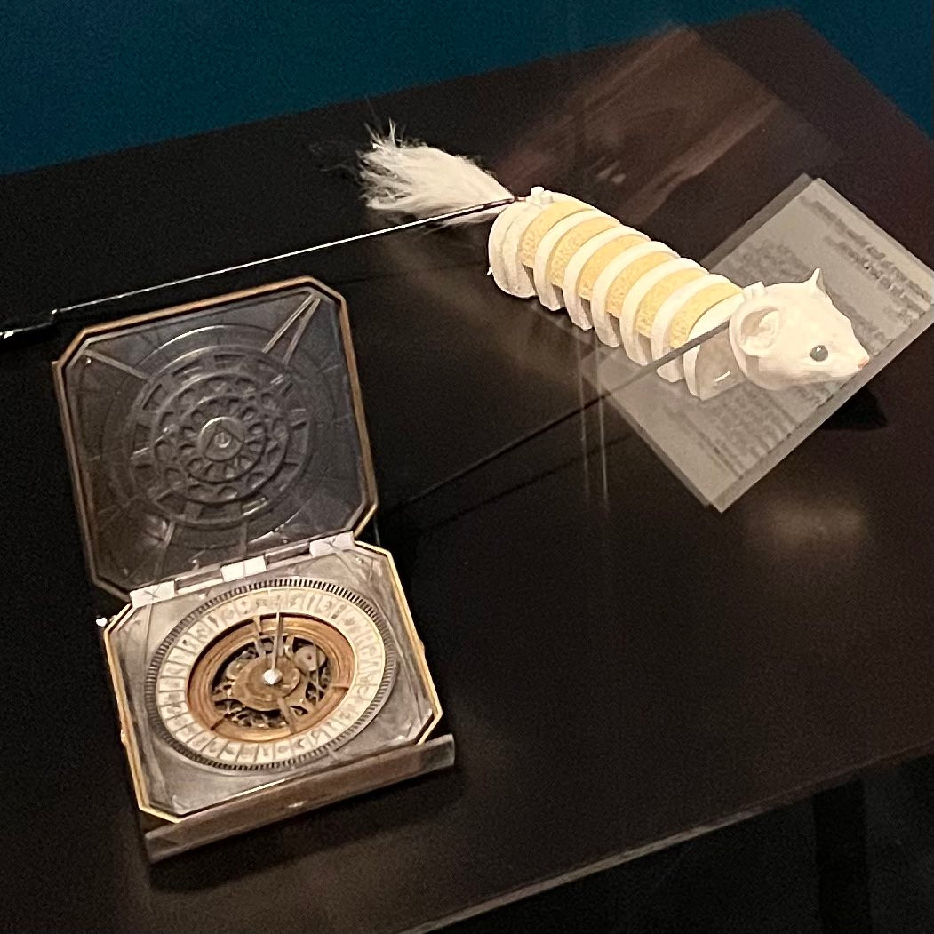 A close-up view from a display in the Theatre & Performance Gallery at The Victoria and Albert Museum (London), featuring items from the HIS DARK MATERIALS TV-show production: an alethiometer and a Pan puper.