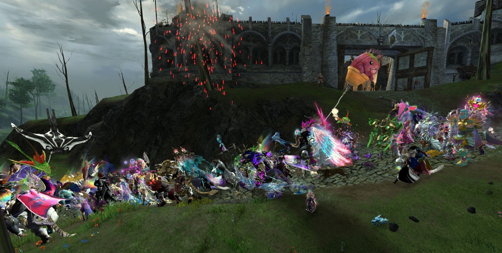 A Guild Wars 2 screenshot of the Tyria Pride March going past an outpost as a red firework goes off.